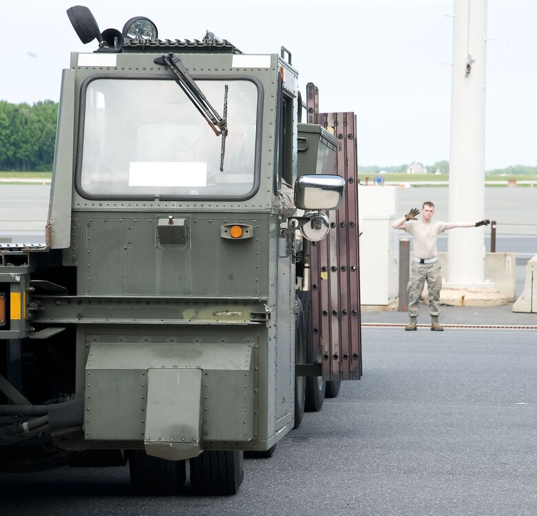 Airman 1st Class Christopher Sims, ramp services specialist with the 436th Aerial Port Squadron, directs a “60K Tunner” K-loader May 24, 2012, at Dover Air Force Base, Del. The 436th APS is in charge of processing cargo that is then shipped across the world. (U.S. Air Force photo by Adrian R. Rowan)