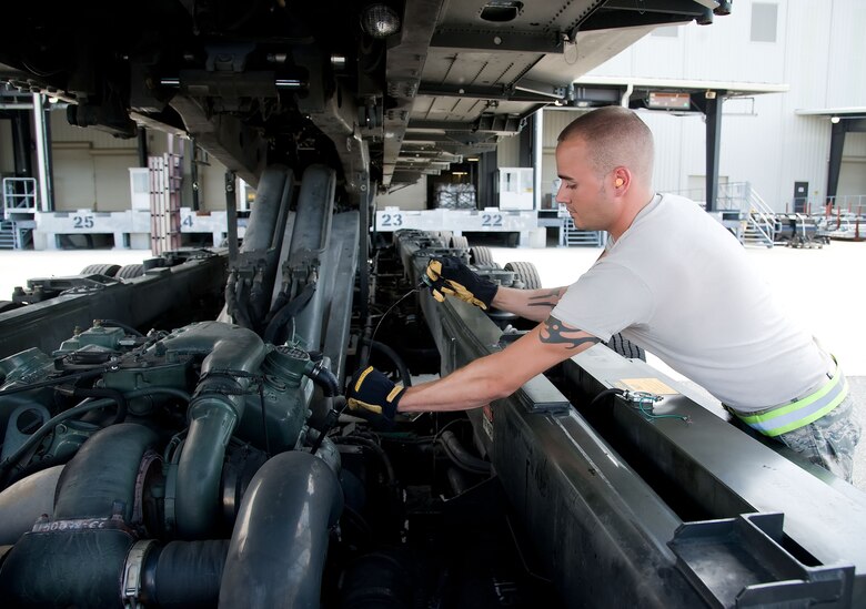 Senior Airman Brandon Dodd, ramp services specialist with the 436th Aerial Port Squadron, checks the oil in a “60K Tunner” K-loader May 24, 2012, at Dover Air Force Base, Del. The 436th APS is in charge of processing cargo that is then shipped across the world. (U.S. Air Force photo by Adrian R. Rowan)