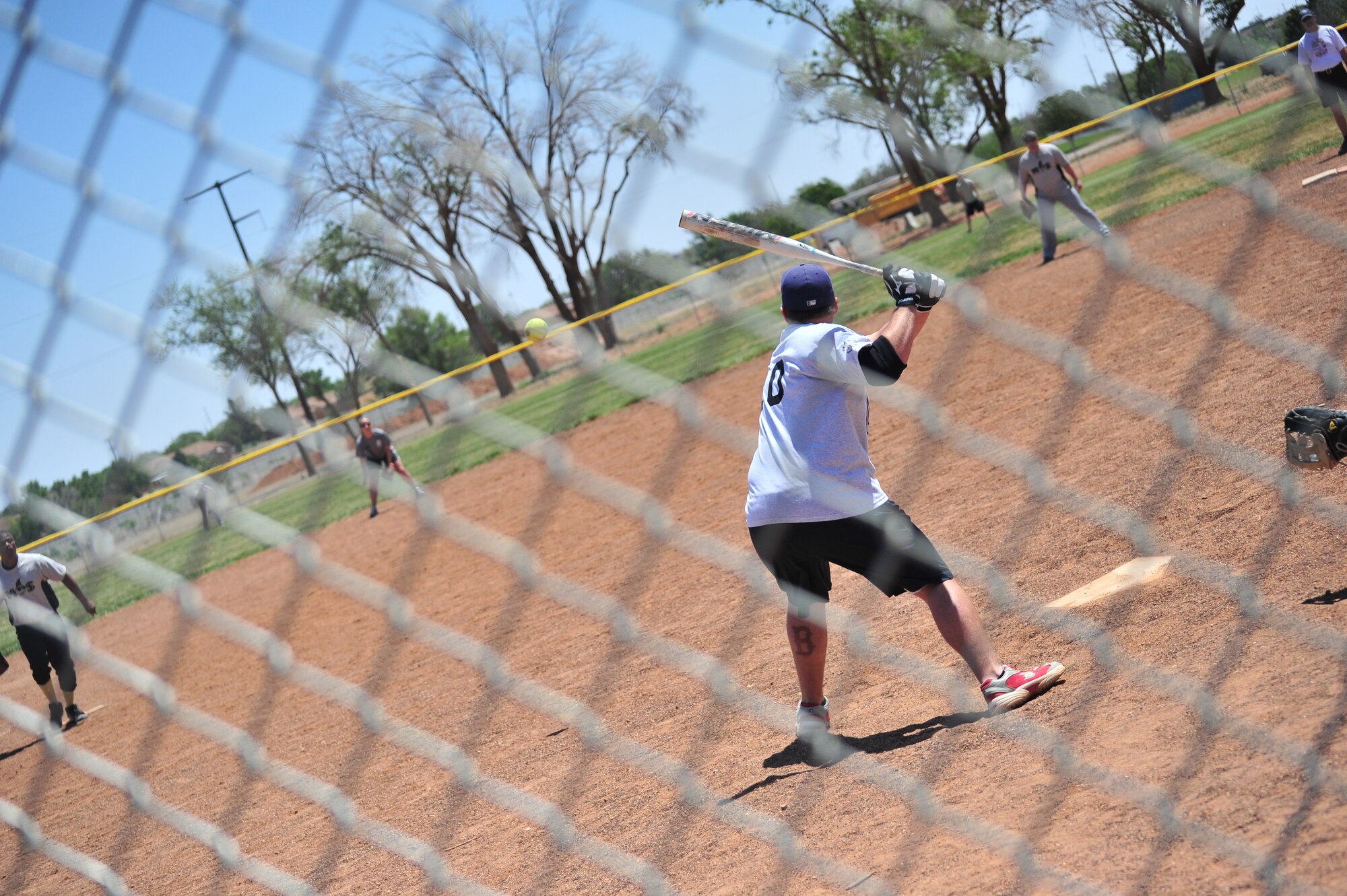 U.S. Air Force Airman 1st Class Anthony Heitman, 27th Special Operations Aircraft Maintenance Squadron crew chief, prepares to swing at a softball during Sports Day at Cannon Air Force Base, N.M., May 18, 2012.  Sports Day was a day for the base to assemble teams together and work toward winning a trophy in various sports activities.  Sports Day was a day for the base to assemble teams together and work toward winning a trophy in various sports activities.  (U.S. Air Force by photo Airman 1st Class Xavier Lockley)
