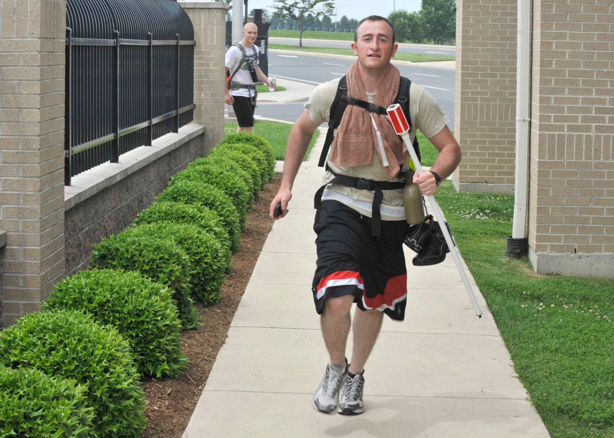 Airman 1st Class Christopher Bobinchak of the 436th Logistics Readiness Squadron runs past the main gate May 24, 2012, on Dover Air Force Base, Del. Bobinchak took part in the Base-2-Base Ruckmarch which went from the Air National Guard base in New Castle to Dover AFB, a total of 47 miles. (U.S. Air Force photo by Tech. Sgt. Chuck Walker)