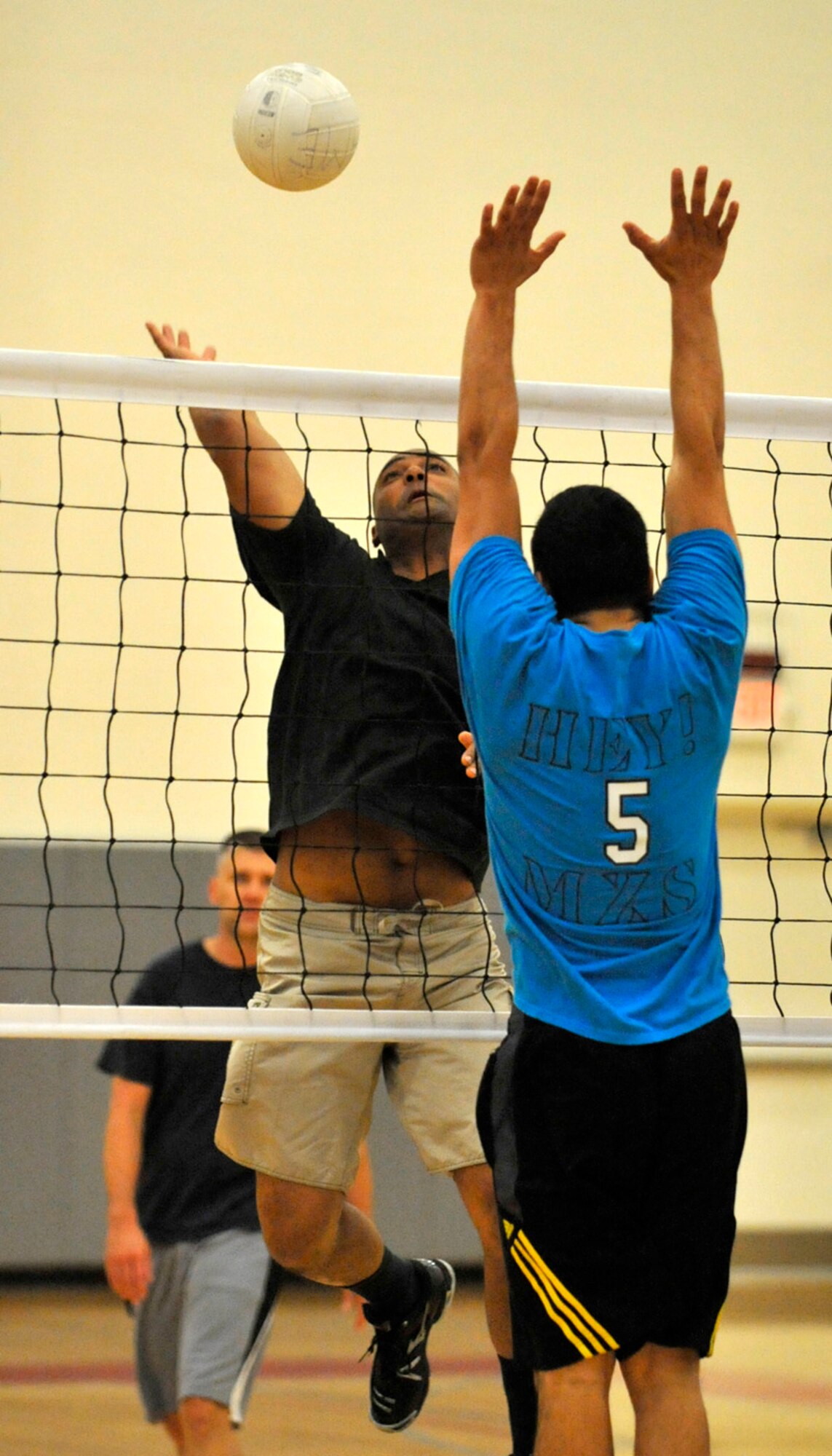 Jon Lu, player-coach with the 736th Aircraft Maintenance Squadron, goes up for a kill as the 436th Maintenance Squadron attempts to block during the base intramural volleyball championship match May 23, 2012, at the Fitness Center on Dover Air Force Base, Del. It took the 736th AMXS two matches and five games to secure the championship. (U.S. Air Force photo by Tech. Sgt. Chuck Walker)
