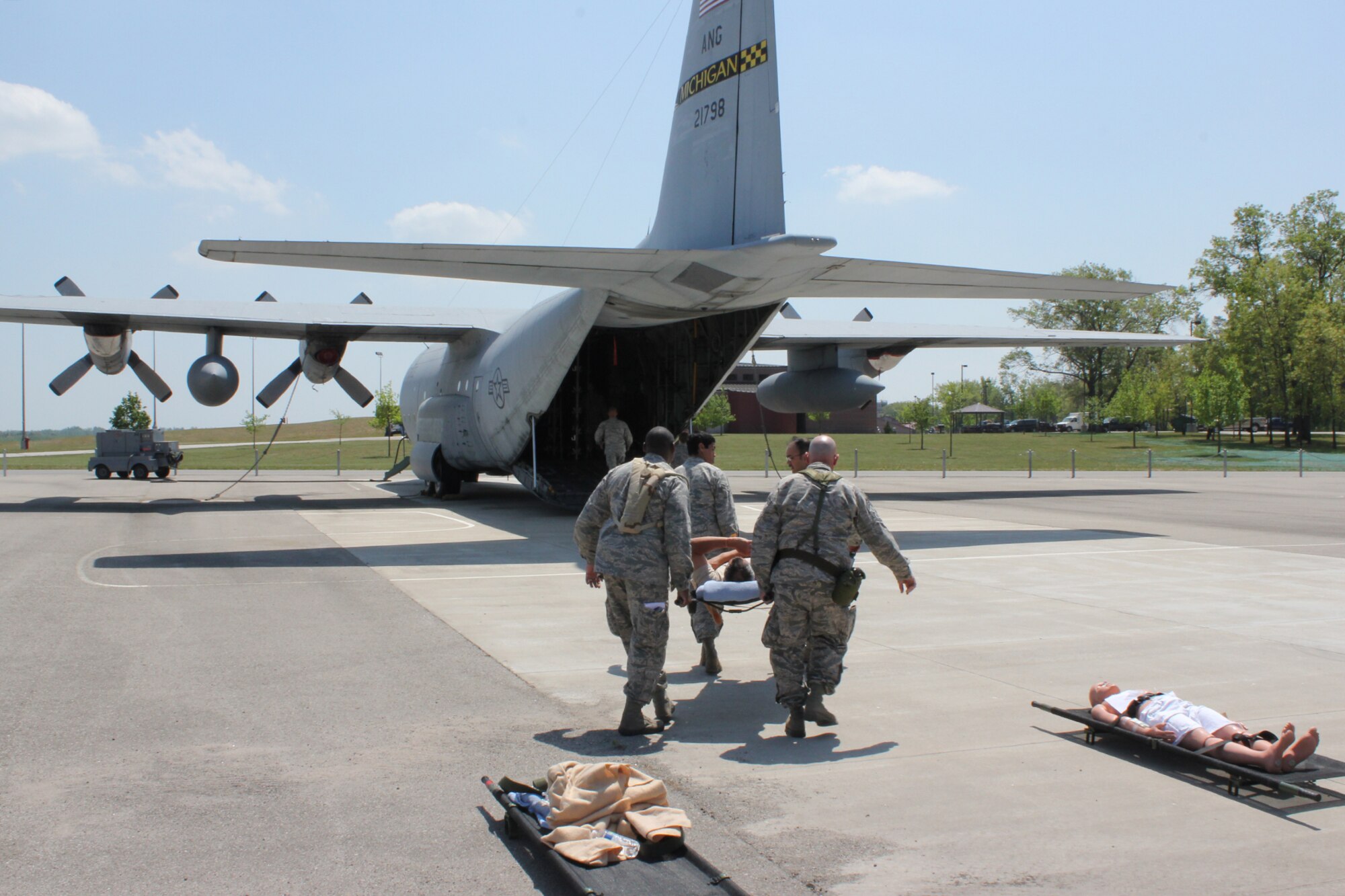 A group of Airmen transport an “injured” patient on to a C-130 Hercules for medical evacuation during a training exercise at the Alpena Combat Readiness Training Center, Mich., May 24, 2012. During the Emergency Medical Training exercise, medical specialists from eight medical groups in seven states gathered to practice responding to a natural disaster. (U.S. Air Force photo by TSgt. Dan Heaton)