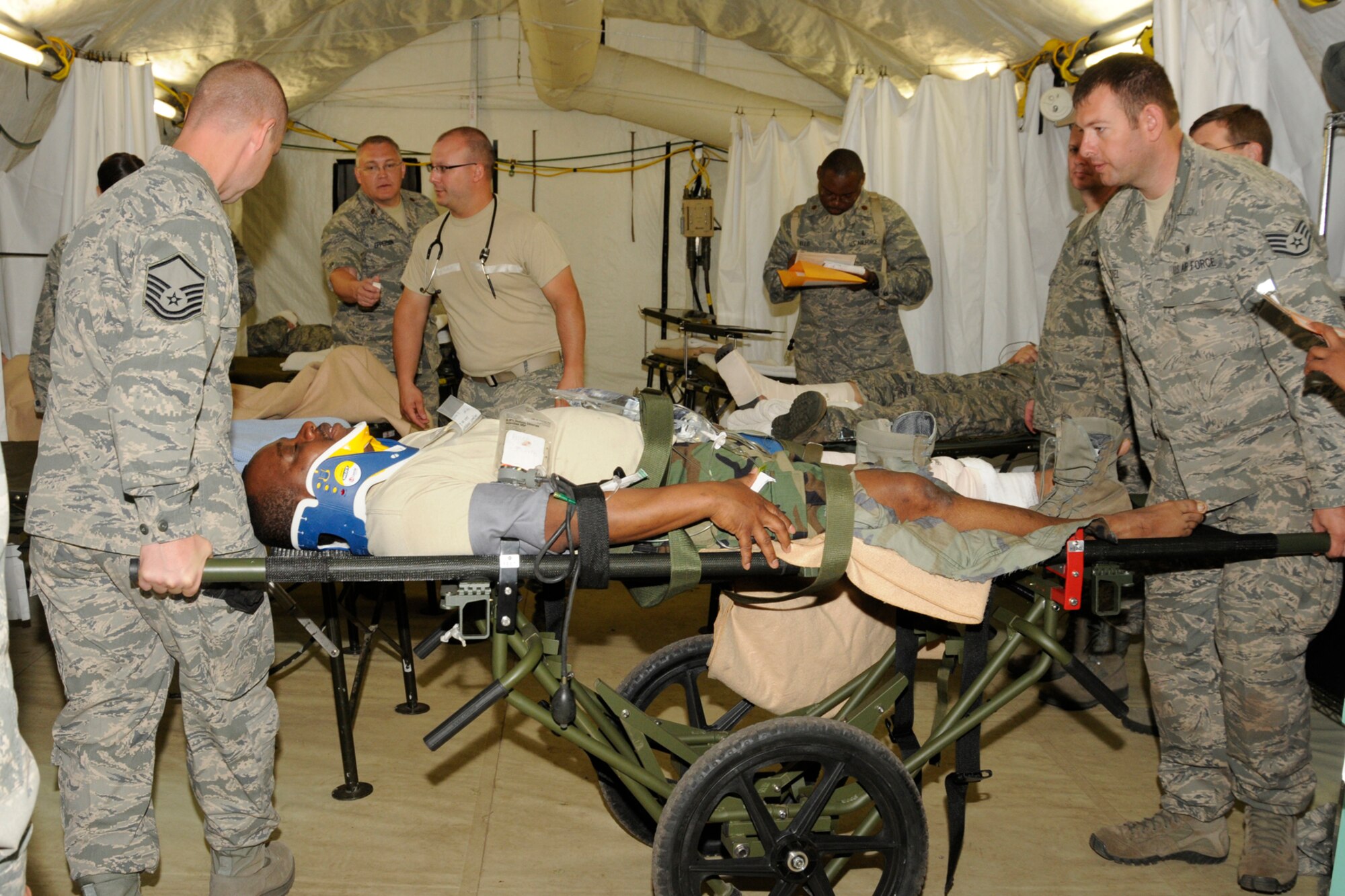 Medical Airmen transport an “injured” Technical Sgt. Kenneth Glanzie into the emergency room during a training exercise at the Alpena Combat Readiness Training Center, Mich., May 24, 2012. During the Emergency Medical Training exercise, medical specialists from eight medical groups in seven states gathered to practice responding to a natural disaster. (U.S. Air Force photo by TSgt. David Kujawa)