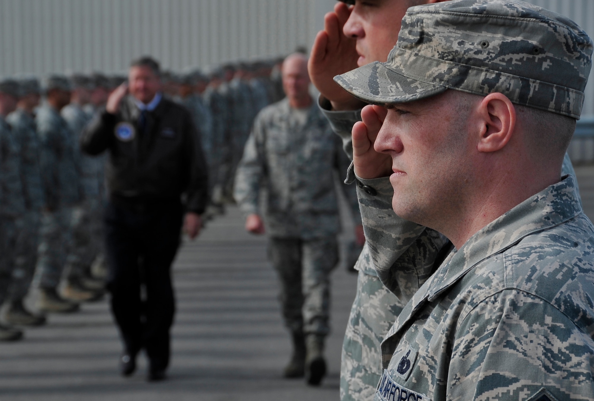 Airmen from the 18th Aircraft Maintenance Unit render a salute to Secretary of the Air Force Michael Donley and Brig. Gen. James Post, 354th Fighter Wing commander, during a visit May 22, 2012, Eielson Air Force Base, Alaska.  Donley visited several locations on base and concluded the trip with an all call at the base theater where he thanked the Iceman Team for their service to the nation. (U.S. Air Force photo/Staff Sgt. Miguel Lara III)
