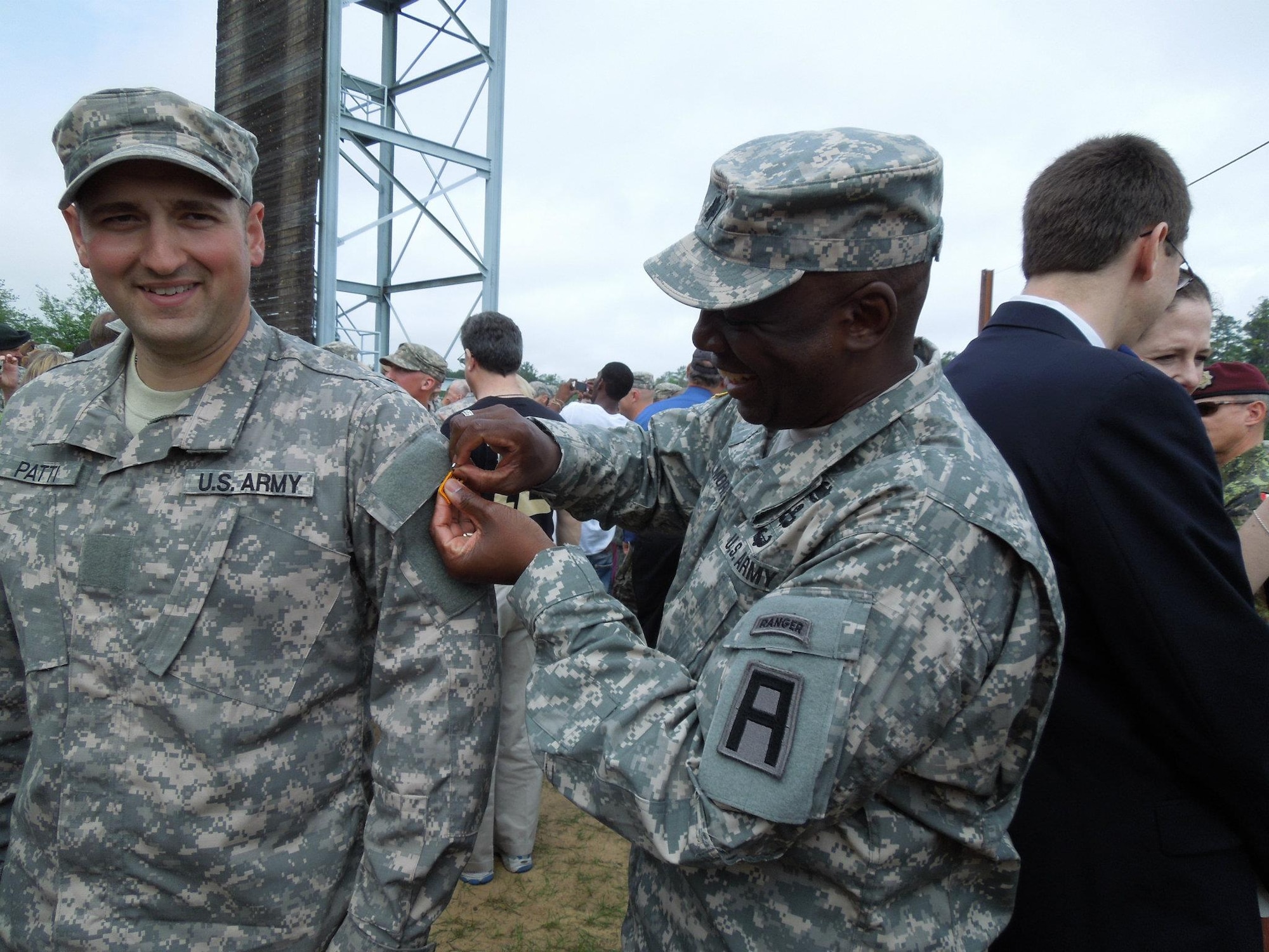 Lt. Col. Lee Elmore, commander, 1st Battalion, 307th Infantry Regiment pins Army Capt. Michael Patti at his Ranger school graduation earlier this month. Patti and another soldier in the battalion trained for 10 weeks before and after duty hours, weekends and holidays, preparing for Ranger school. (U.S. Army courtesy photo/Released)