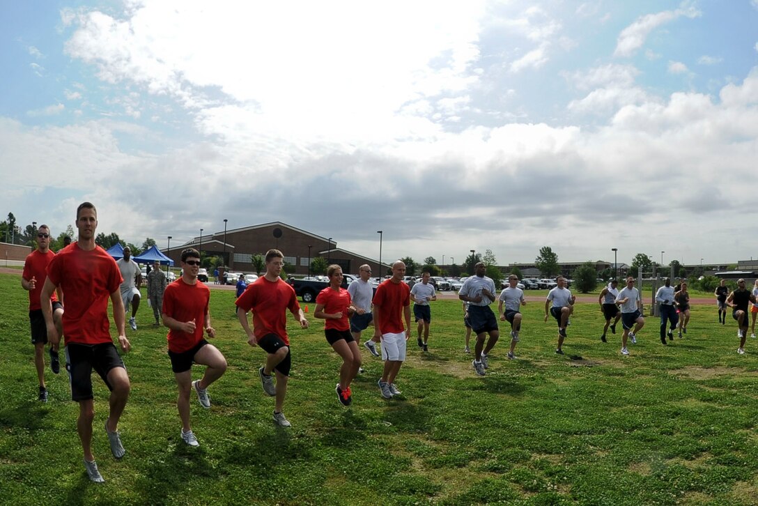 Airmen from Langley Air Force Base, Va., warm up prior to the start of the Squadron Fitness Challenge at the base track, May 24, 2012. The challenge consisted of several events including a sled pull, tire flip and obstacle course. (U.S. Air Force photo by Senior Airman Wesley Farnsworth/Released) 