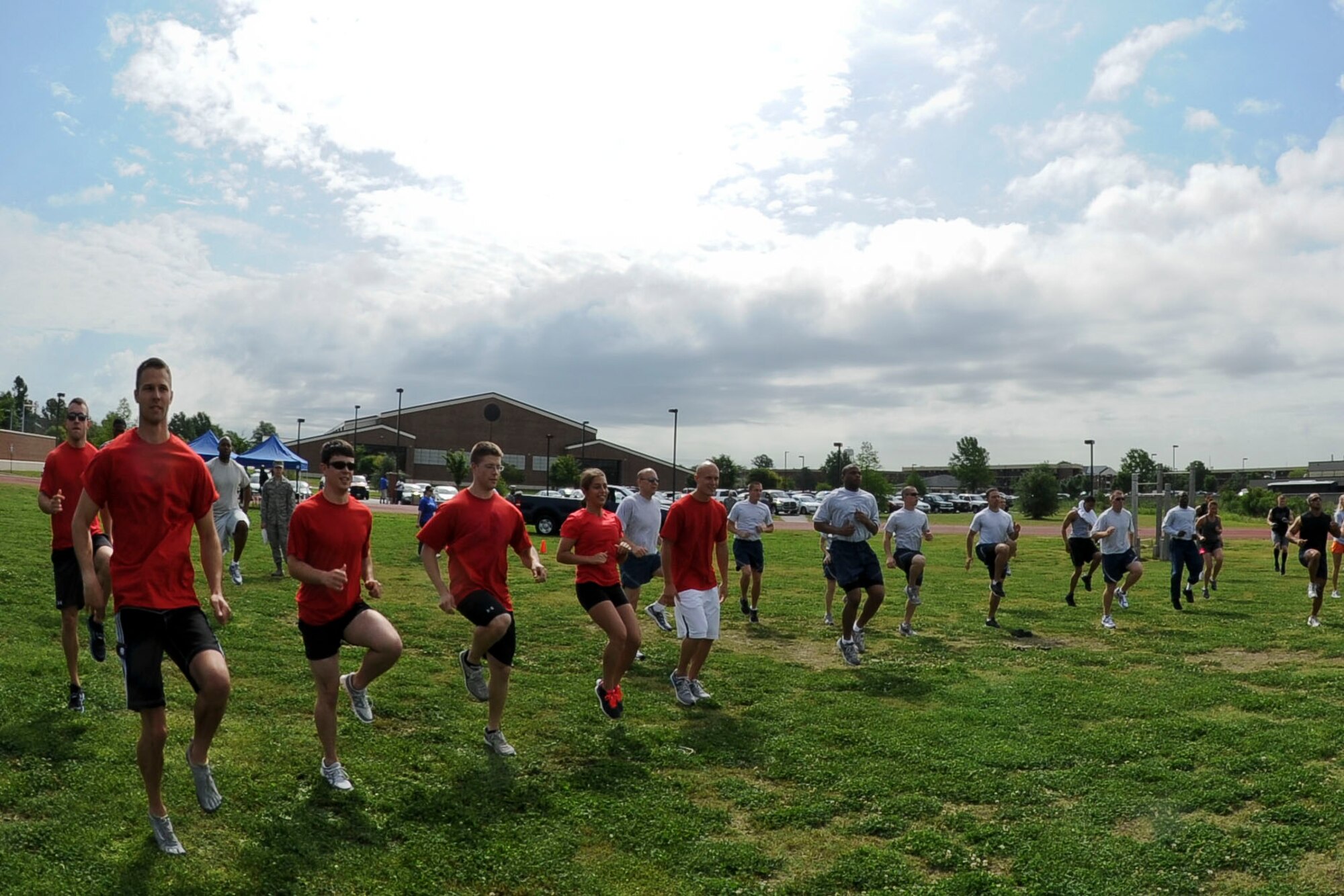 Airmen from Langley Air Force Base, Va., warm up prior to the start of the Squadron Fitness Challenge at the base track, May 24, 2012. The challenge consisted of several events including a sled pull, tire flip and obstacle course. (U.S. Air Force photo by Senior Airman Wesley Farnsworth/Released) 