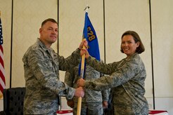 Colonel Richard McComb, Joint Base Charleston commander, passes the squadron guidon to Maj. Laurie-An Lanpher, 628th Comptroller Squadron incoming commander, during the 628th CPTS Change of Command ceremony at JB Charleston - Air Base, S.C., May 23, 2012. The passing over of the guidon symbolizes the changing of a command. (U.S. Air Force photo/Airman 1st Class George Goslin