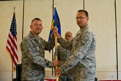 Colonel Richard McComb, Joint Base Charleston commander, takes the squadron guidon from Lt. Col. Trevor Whitehill, 628th Comptroller Squadron outgoing commander, during the 628th CPTS Change of Command ceremony at JB Charleston - Air Base, S.C., May 23, 2012. The passing over of the guidon symbolizes the changing of a command. (U.S. Air Force photo/Airman 1st Class George Goslin) 
