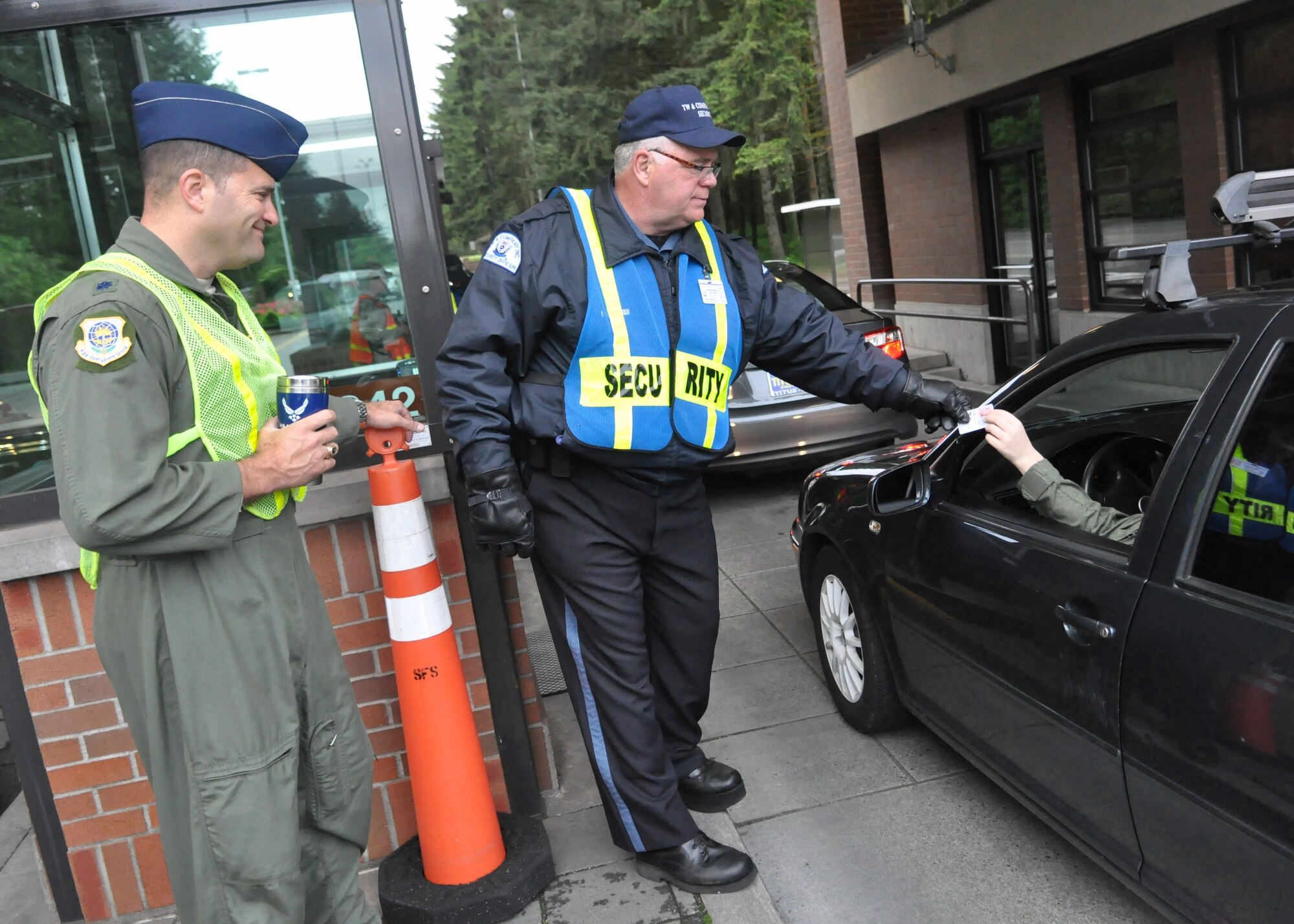 Lt. Col. Eric Carney, 62nd Operations Group, greets Airmen as they drive through the gate during the morning commute May 24, 2012, at Joint Base Lewis-McChord, Wash. Leaders encouraged McChord Field personnel to have a safe and enjoyable holiday weekend. (U.S. Air Force photo/Senior Airman Leah Young)