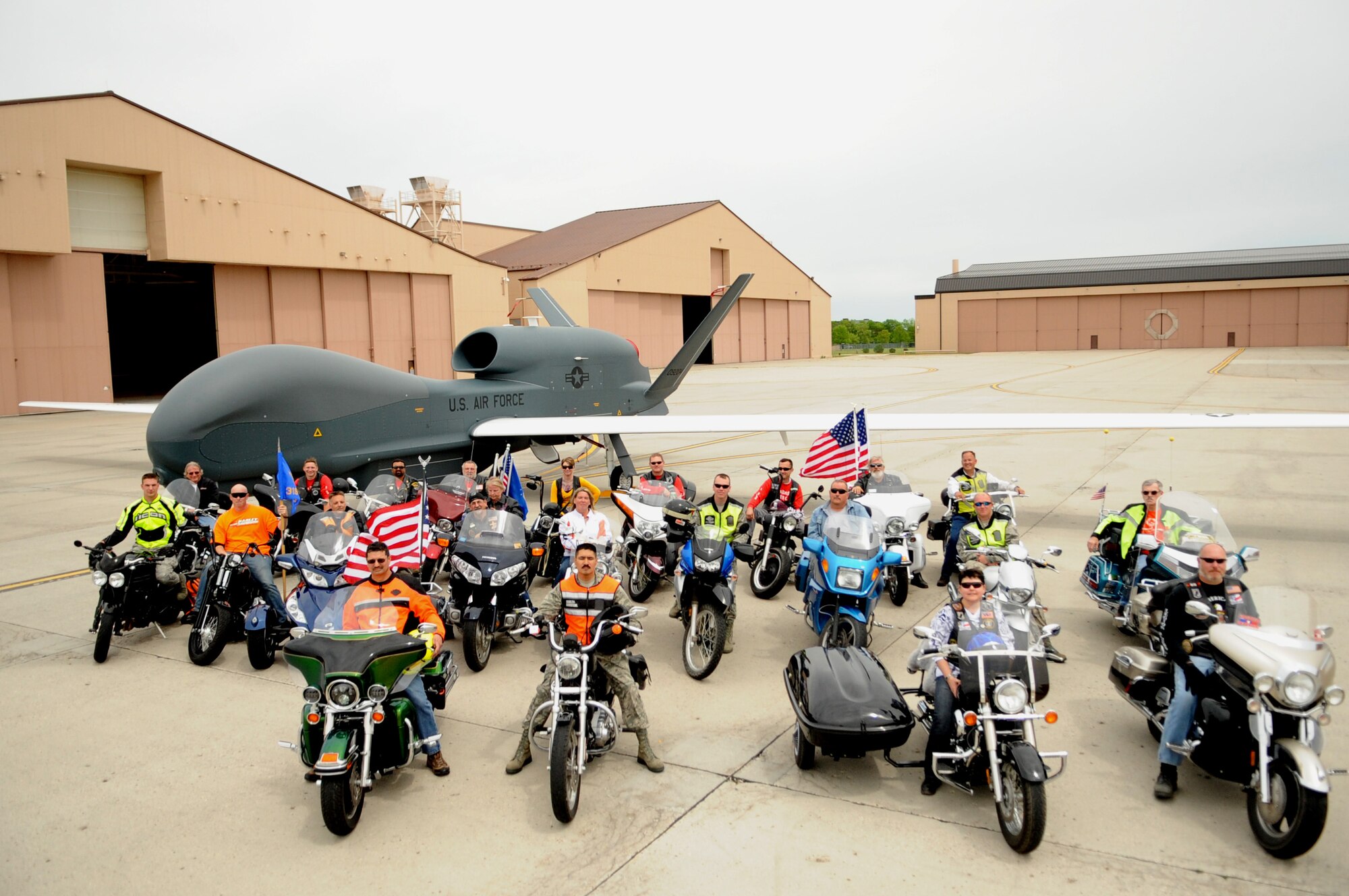 Participants from Motorcycle Rally and Safety Fair pose for a picture in front of a Global Hawk on Grand Forks Air Force Base, N.D. May 23, 2012. (U.S. Air Force photo by Staff Sgt. Amanda N. Grabiec)