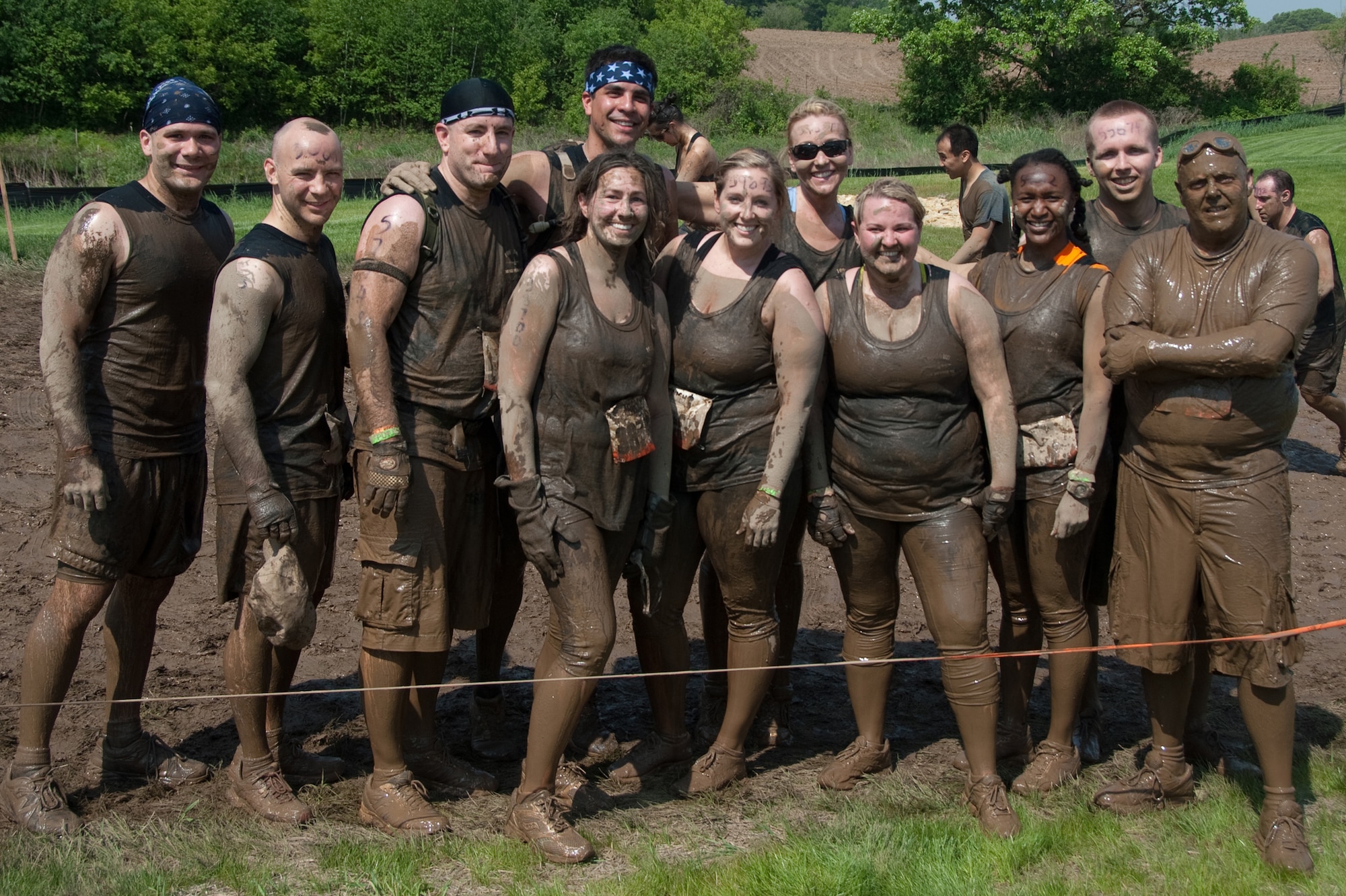 Members of the 109th Aeromedical Evacuation Squadron, Minnesota Air National Guard team pause for a moment during the Tough Mudder obstacle course in Somerset, Wis. on May 19, 2012.  Front row left to right: Staff Sgt. Greg White, Capt. Chris Wolf, Maj. Dominic Ehman, Tech. Sgt. Aubree Roberts, 1st Lt. Stacy Nephew, Tech. Sgt. Rose Vlaisavljevich, Tech. Sgt. CeCe Young, 1st Lt. James Mattson. Back row left to right: Tech. Sgt. Matthew Monjes, Capt. Jackie Wheeler, Airman 1st Class Jordan Berry. There were at least a dozen others from the 133rd Airlift Wing getting muddy for exercise, camaraderie, and to help raise money for the Wounded Warrior project.  U.S. Air Force Photo by Staff Sgt. Jonathan Young