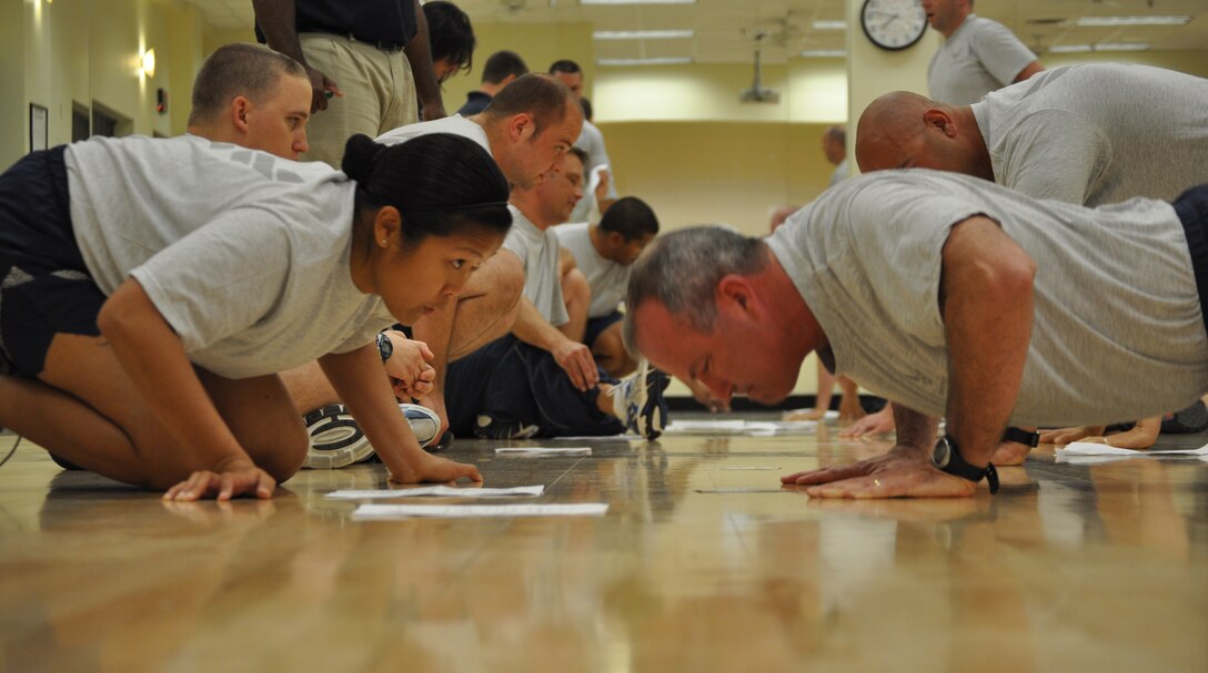 Brig. Gen. Michael A. Fantini performs push-up repetitions while Master Sgt. Gen Vicente counted on May 24, 2012 at Sheppard Air Force Base. Fantini took his physical fitness test at the Pitsenbarger Fitness Center. (U.S. Air Force photo/2nd Lt. Jerred Moon)
