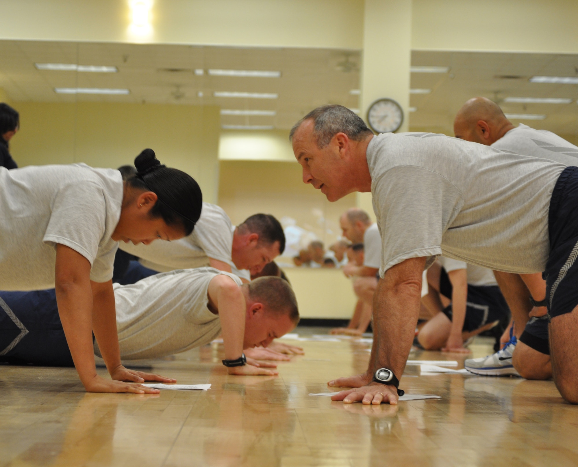 Brig. Gen. Michael A. Fantini counts push-up repetitions of Master Sgt. Gen Vicente on May 24, 2012 at Sheppard Air Force Base. Fantini was sure to keep everyone up to standard including himself during the physical fitness test. (U.S. Air Force photo/2nd Lt. Jerred Moon)
