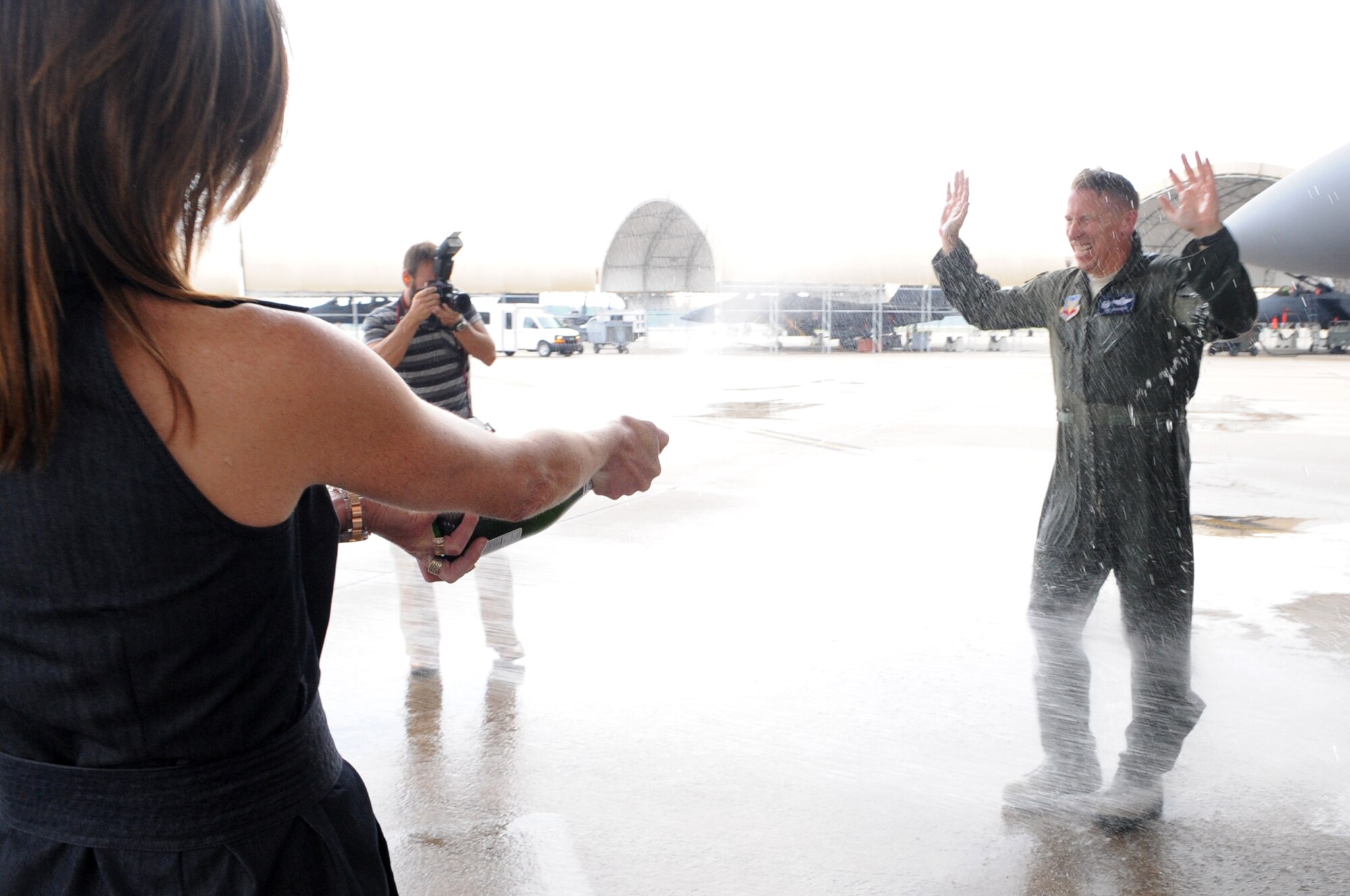 U.S. Air Force Col. Patrick Doherty is hosed down by family members following his final flight in an F-15E Strike Eagle as the 4th Fighter Wing commander on Seymour Johnson Air Force Base, N.C., May 23, 2012. It is an Air Force tradition to have family, friends and Airmen from the wing toast the departing aircrew member and hose them down with water as they debark the aircraft. Doherty will relinquish command of the 4th FW to Col. Jeannie Leavitt in a change-of-command ceremony, June 1. (U.S. Air Force photo/Airman 1st Class Aubrey Robinson/Released)