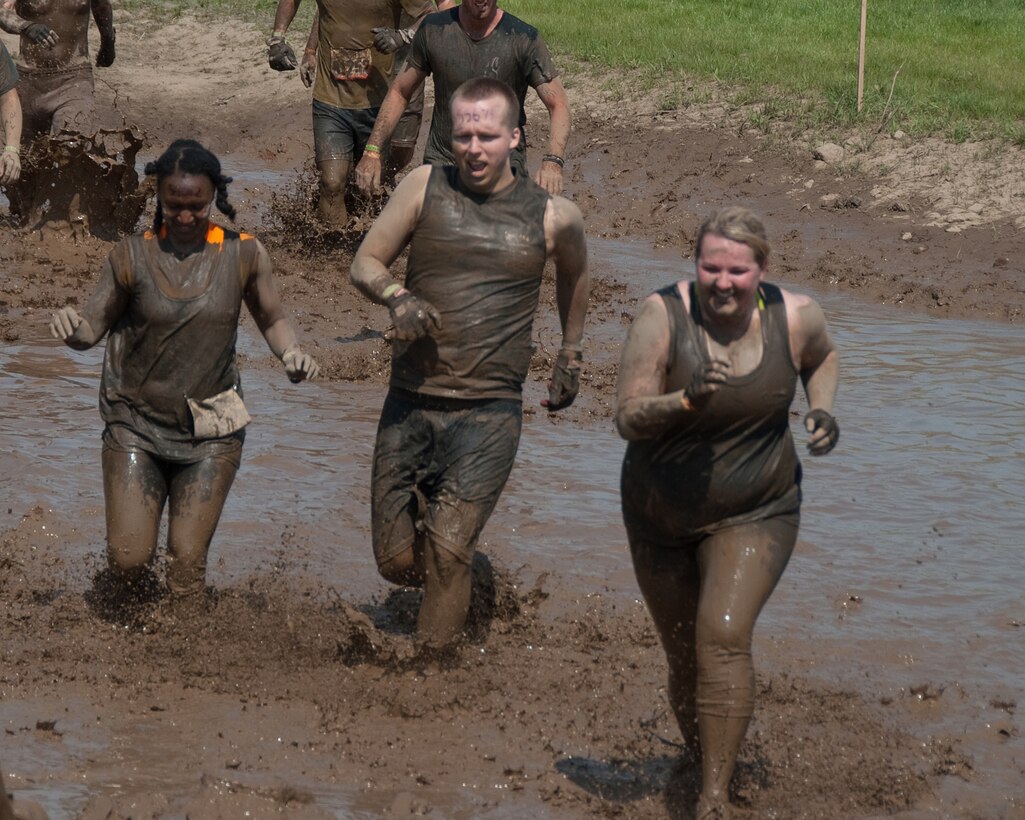 Members of the 109th Aeromedical Evacuation Squadron, Minnesota Air National Guard team plow through the Tough Mudder obstacle course in Somerset, Wis. on May 19, 2012.  About a dozen Aeromeds made up one team and there were at least a dozen others from the 133rd Airlift Wing getting muddy for exercise, camaraderie, and to help raise money for the Wounded Warrior project.  U.S. Air Force Photo by Staff Sgt. Jonathan Young