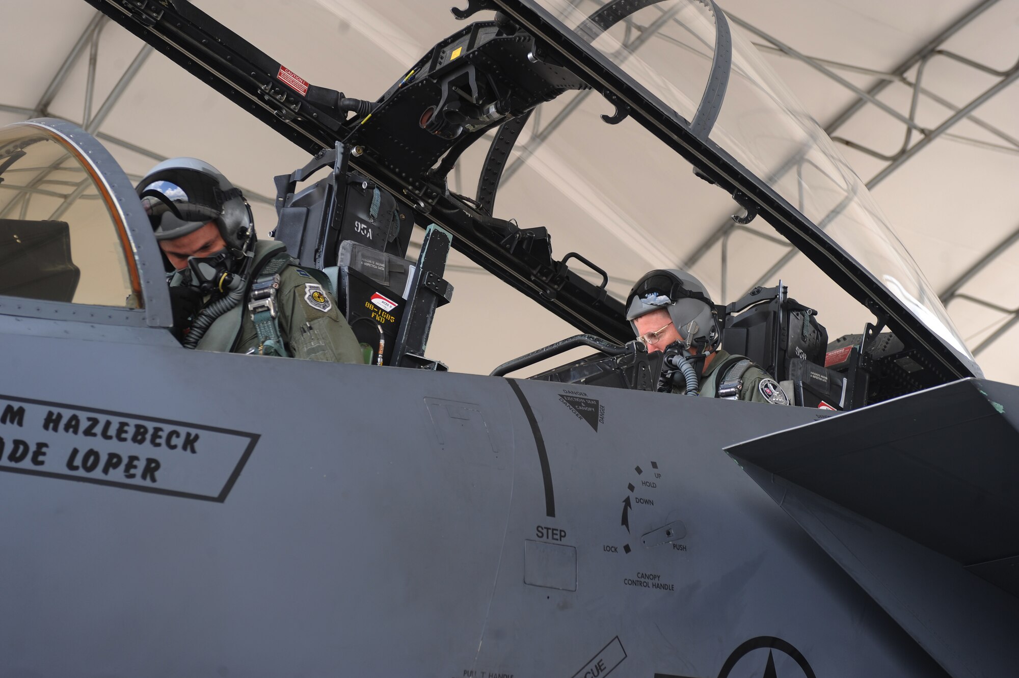 U.S. Air Force Capt. Stephen Thomas (left) and Col. Scott Caine check over flight equipment inside an F-15E Strike Eagle’s cockpit prior to taking off from Seymour Johnson Air Force Base, N.C., May 22, 2012. Thomas, 333rd Fighter Squadron weapons flight commander, is from Tampa, Fla. Caine is the new 9th Air Force vice commander. (U.S. Air Force photo/Airman 1st Class John Nieves Camacho/Released)