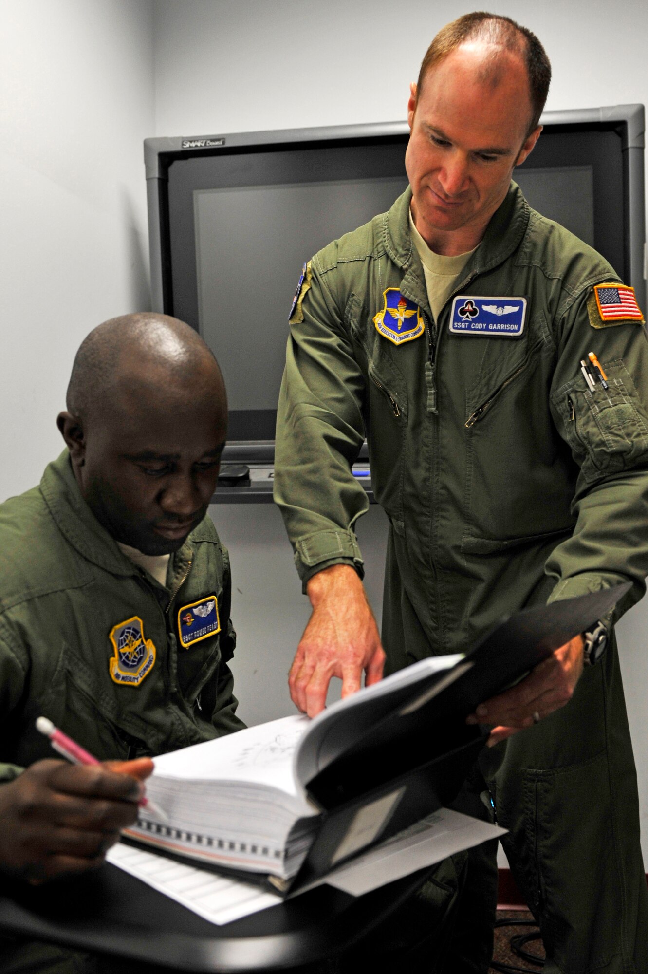 Staff Sgt. Cody Garrison, a 62nd Airlift Squadron flight engineer instructor, reviews a C-130H engine systems technical order with Staff Sgt. Romeo Peart, a 2nd Airlift Squadron student flight engineer, May 24, 2012, at Little Rock Air Force Base, Ark. Garrison received an overall commendable evaluation grade for his excellent instructor abilities, the grade was the highest rating received during the Higher Headquarters Inspection. (U.S. Air Force photo by Airman 1st Class Rusty Frank) 
