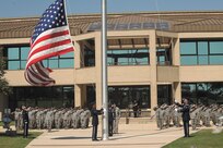 Airmen from the 902nd and 802nd Security Forces Squadrons render a salute as the American flag is lowered during the National Police Week retreat ceremony May 18 at Joint Base San Antonio-Lackland.. (U.S. Air Force photo/Robbin Cresswell)
