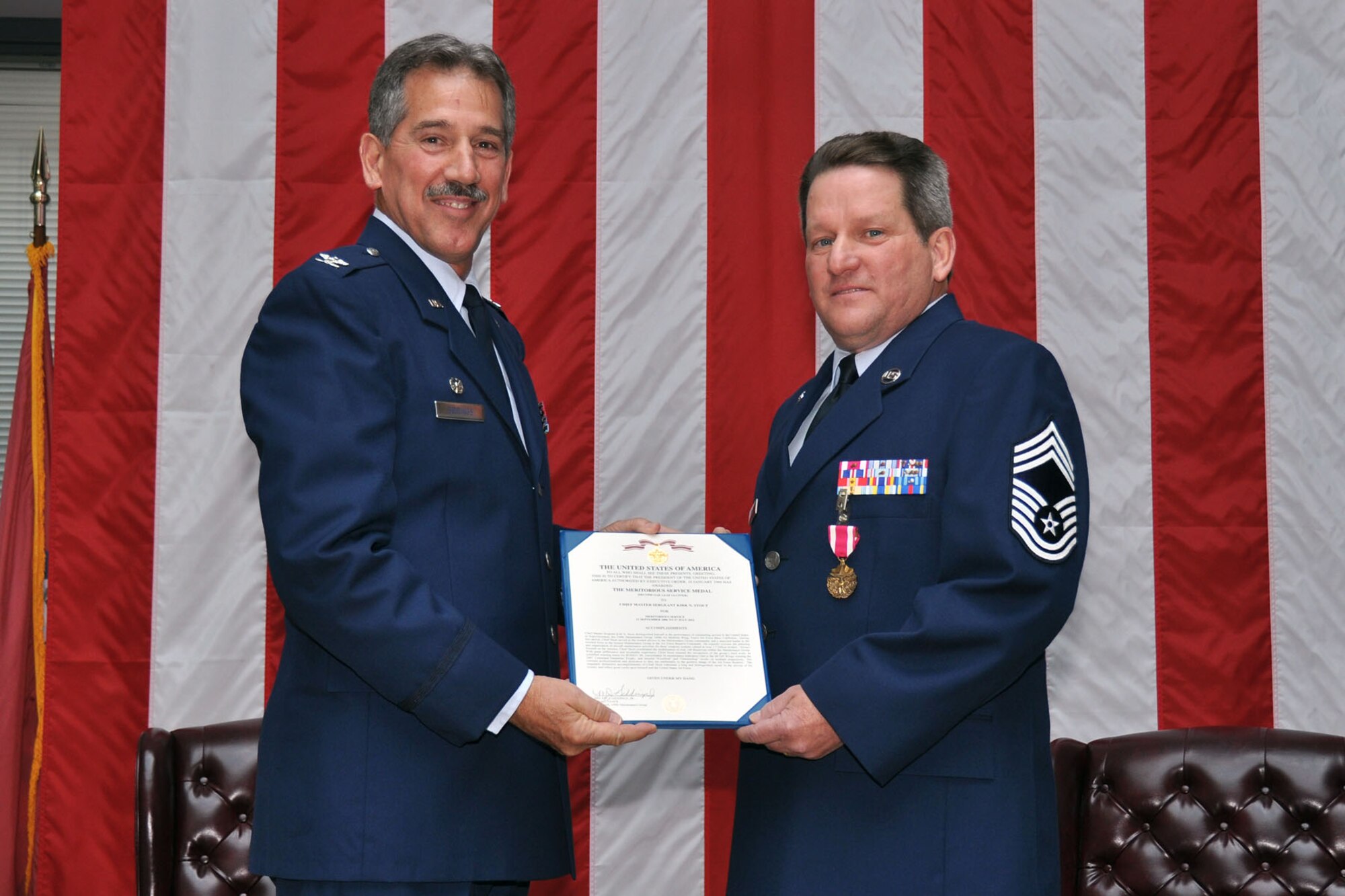 TRAVIS AIR FORCE BASE, Calif. -- Chief Master Sgt. Kirk N. Stout, 349th Maintenance Group superintendent, receives the Meritorious Service medal from Col. Melvin J. Giddings, Jr., 349th Maintenance Group commander, during his retirement ceremony here. CMSgt. Stout retired after serving in the Air Force in various positions for nearly 35 years. (U.S. Air Force photo / Senior Airman Cindy Alejandrez) 