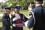 Airman Noel Cortez, Airman 1st Class Jason Miller, Staff Sgt. Jason Hamon and Senior Airman Jacob Leon, Joint Base San Antonio-Lackland Honor Guard, fold the American flag during the National Police Week retreat ceremony May 18 at JBSA-Lackland. The event honored fallen police officers. (U.S. Air Force photo/Robbin Cresswell)
