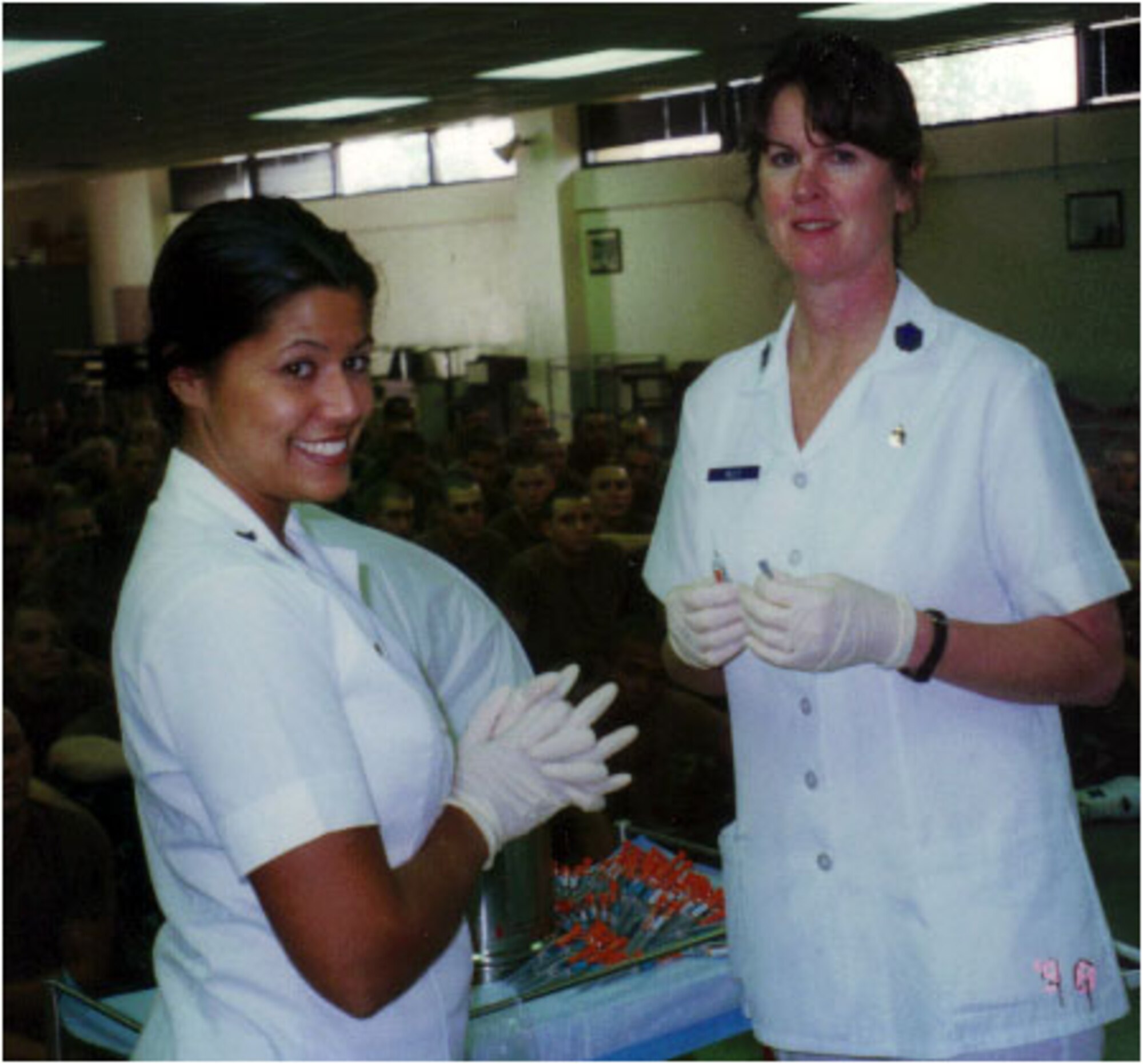 TRAVIS AIR FORCE BASE, Calif. -- Master Sgt. Kelly and Senior Airman Melissa C. Delpilar preparing immunizations for the basic training recruits in 1999 during annual tour at Lackland AFB, Texas. (U.S. Air Force courtesy photo)  