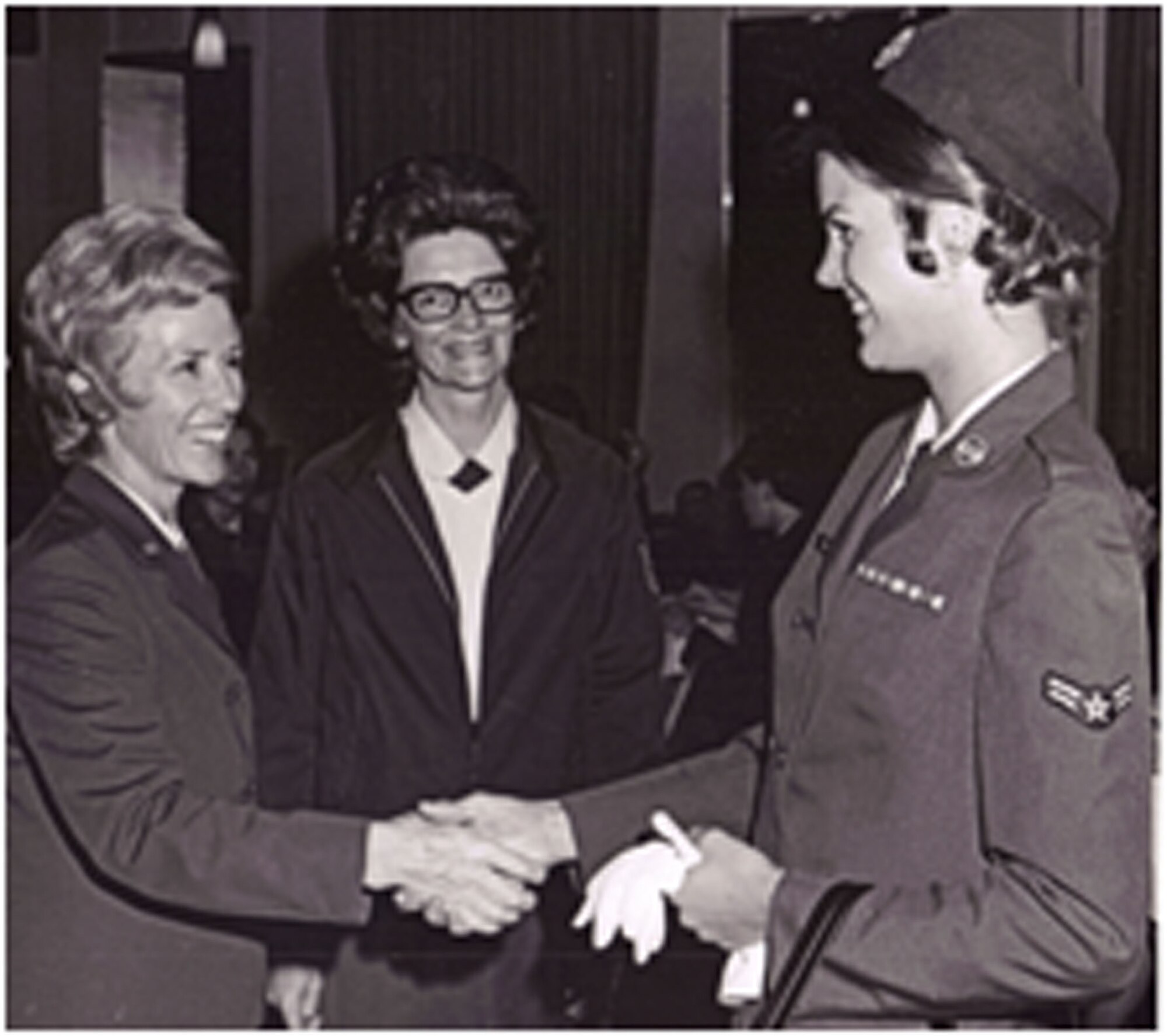 TRAVIS AIR FORCE BASE, Calif. -- Master Sgt. Peggy Kelly,349th Aerospace Medicine Squadron, pictured here as an airman first class shaking hands with the USAF first female General Officer Jeanne M. Holm. (U.S. Air Force courtesy photo)  