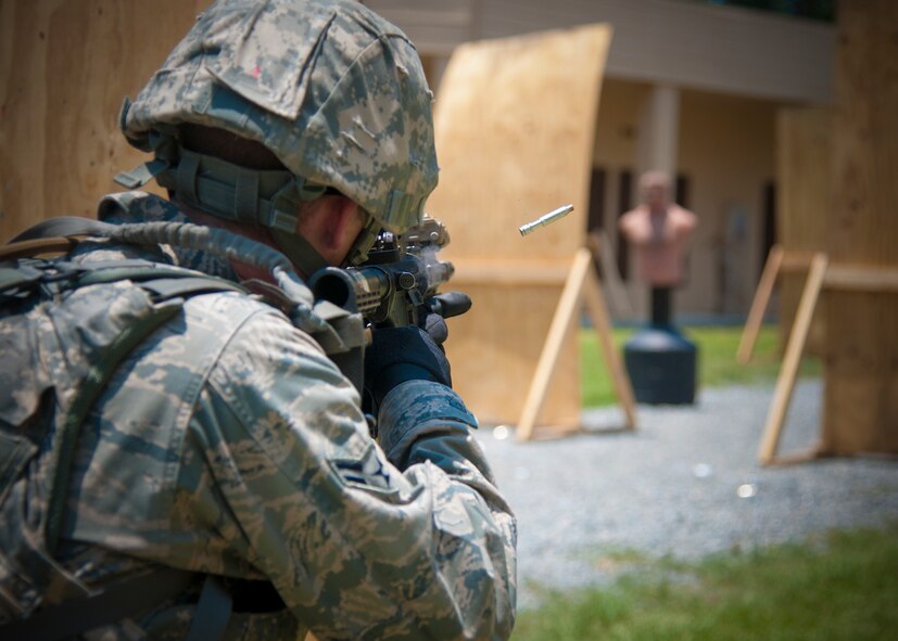 U.S. Air Force Airman 1st Class David Peters, 355th Security Forces Squadron out of Davis-Monthan Air Force Base, Ariz., shoots at targets during a shoot, move and communicate drill at Moody Air Force Base, Ga., May 23, 2012. Participating teams consisted of four members with 15 rounds of non-lethal training ammunition.  The Airmen maintained proper communication while advancing through the course and eliminating threats. (U.S. Air Force photo by Airman 1st Class Paul Francis/Released)

