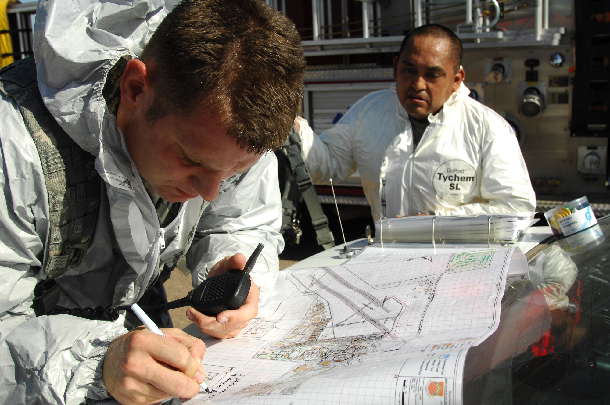 Tech. Sgt. Jeffrey Fluck, 56th Security Forces Squadron patrolman, marks an entry control point and traffic control points around the contaminated area on a base map during the Crown Talon 12-02 Chemical Biological Radiological Nuclear and Explosive exercise near the Logistics Readiness Squadron May 17. The exercise simulated radiation from a Radiological Dispersal Device also commonly known as a dirty bomb.   (U.S. Air Force photo by Senior Airman Sandra Welch)