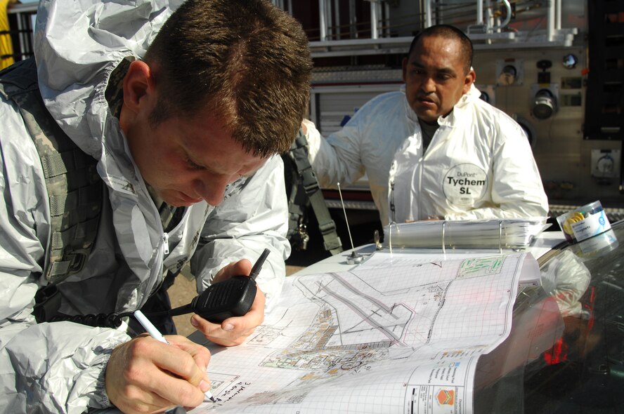 Tech. Sgt. Jeffrey Fluck, 56th Security Forces Squadron patrolman, marks an entry control point and traffic control points around the contaminated area on a base map during the Crown Talon 12-02 Chemical Biological Radiological Nuclear and Explosive exercise near the Logistics Readiness Squadron May 17. The exercise simulated radiation from a Radiological Dispersal Device also commonly known as a dirty bomb.   (U.S. Air Force photo by Senior Airman Sandra Welch)