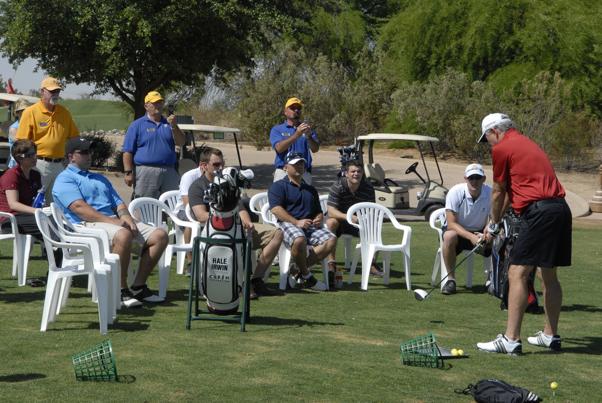 Hale Irwin, professional golfer, demonstrates how to have a natural stance when swinging the golf club for the participants during a golf clinic at the Luke Air Force Base Falcon Dunes golf course May 15. Irwin intends to host more golf clinics in the future.  (U.S. Air Force photo by Airman 1st Class Grace Lee)