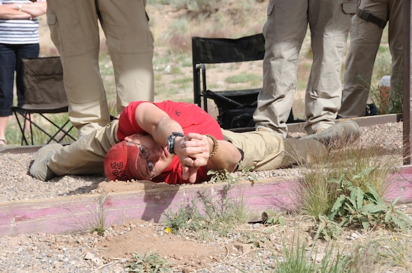 KIRTLAND AFB, N.M. -- Staff Sgt. Dustin Walker, 377th Security Forces Group Combat Arms instructor, demonstrates a shooting position May 18 during the Police Week shooting competition. (Photo by Dennis Carlson) 