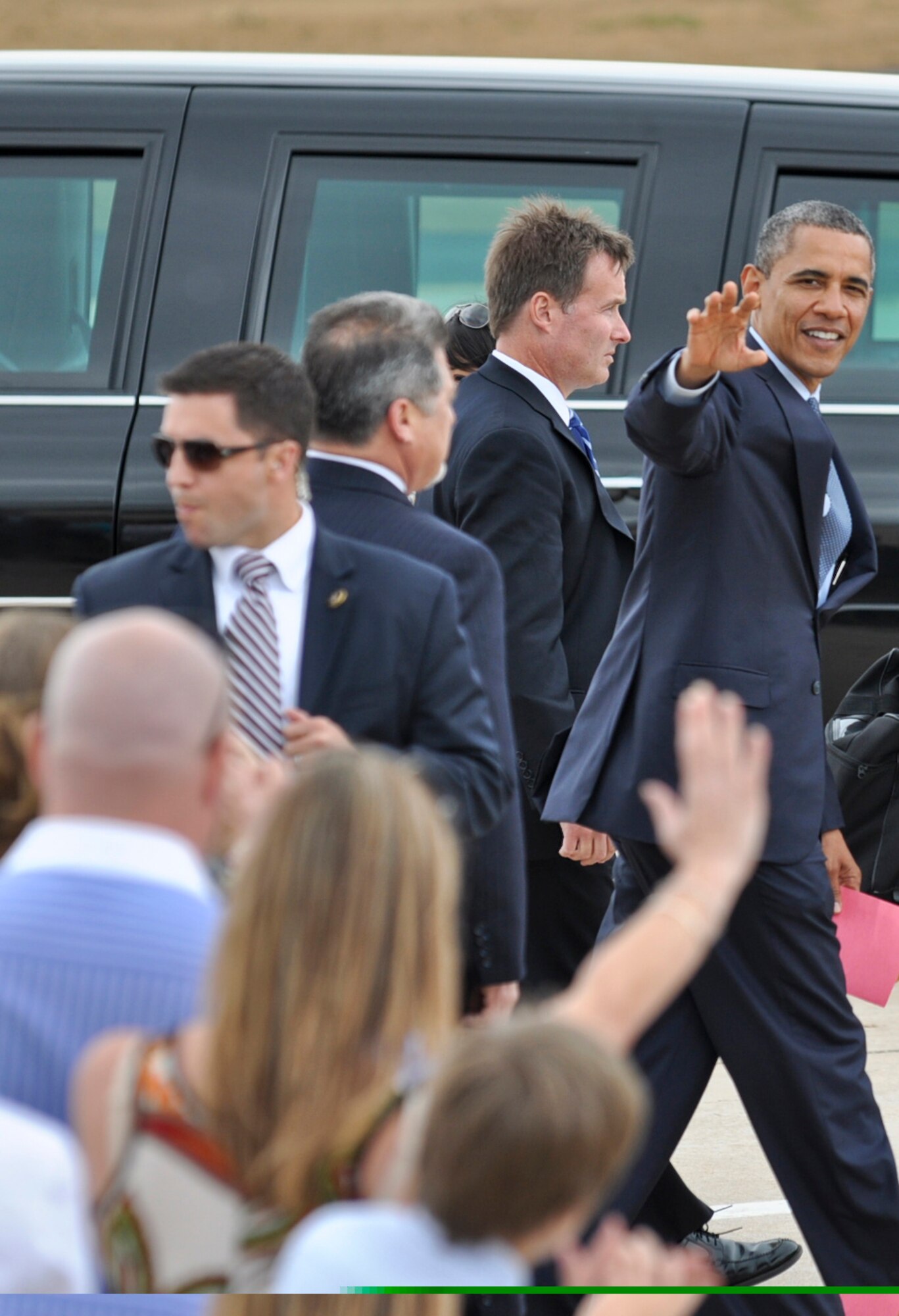 BUCKLEY AIR FORCE BASE, Colo. -- President Barack Obama waves goodbye to the crowd as he gets ready to head downtown after landing here May 23, 2012. Obama was escorted to downtown Denver where he made a public appearance and left Buckley a short time afterward. (U.S. Air Force photo by Senior Airman Christopher Gross)