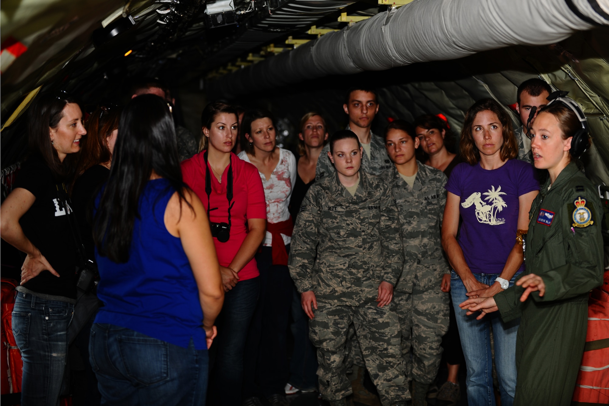 SPANGDAHLEM AIR BASE, Germany – Capt. Catherine Blake, right, 351st Air Refueling Squadron KC-135 Stratotanker pilot, gives a safety briefing to 25 52nd Fighter Wing Airmen and spouses before an orientation flight here May 23. The Airmen and spouses flew on a 351st ARS KC-135 stationed out of Royal Air Force Mildenhall, England during an in-flight refueling of 81st and 480th Fighter Squadron aircraft from Spangdahlem AB. The 351st ARS and 52nd FW aircrew train together to enhance their interoperability to perform in-flight refueling missions. (U.S. Air Force photo by Airman 1st Class Matthew B. Fredericks/Released)