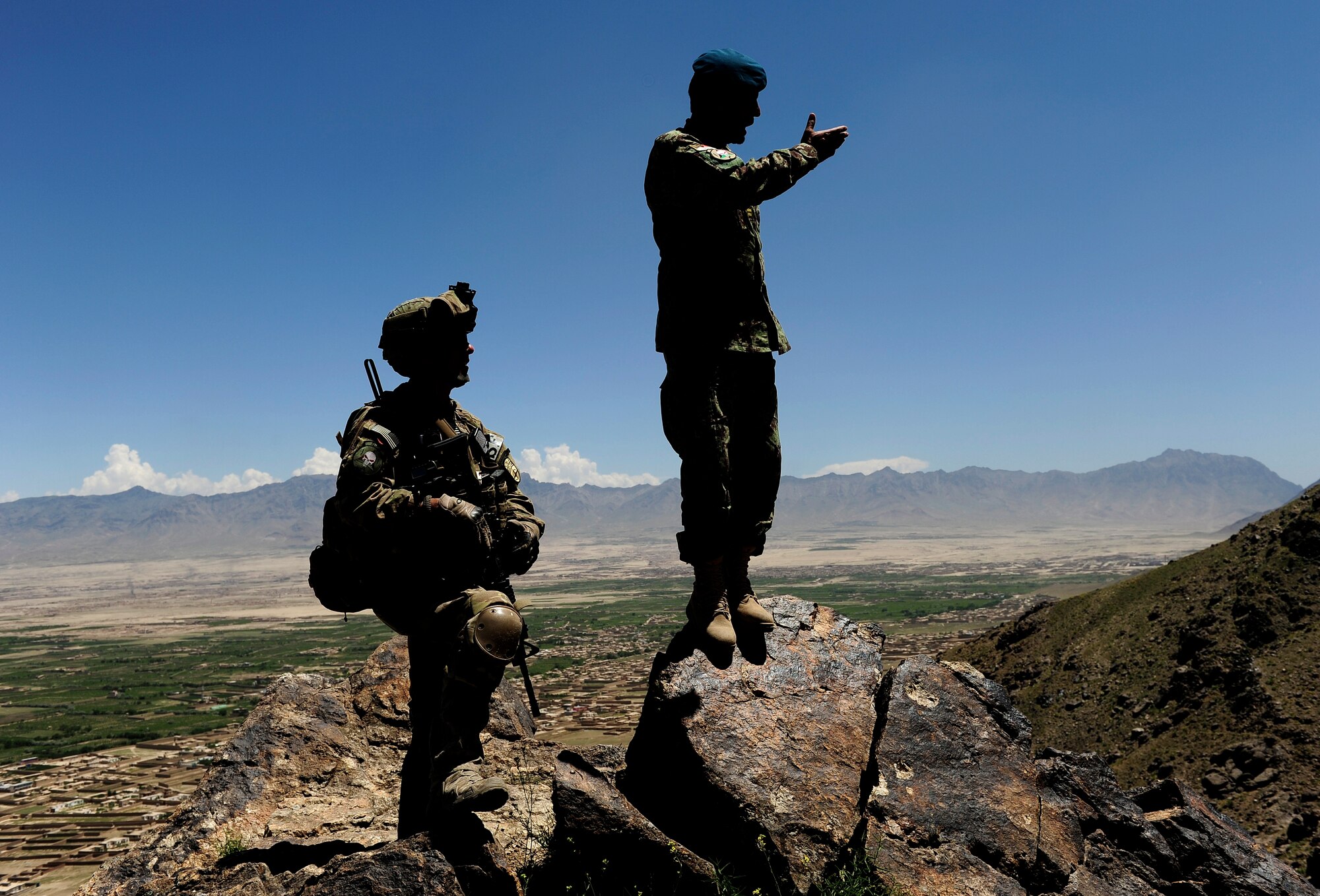 An Air Force Security Forces member from the 439th Air Expeditionary Advisor Squadron helps advise a  member of the Afghan Air Force during a mounted and dismounted patrol outside of Kabul, Afghanistan, May 21, 2012. The mission, which was the first Afghan led quick reaction force patrol, consisted of a mounted and dismounted patrol. (U.S. Air Force photo/Staff Sgt. Clay Lancaster)