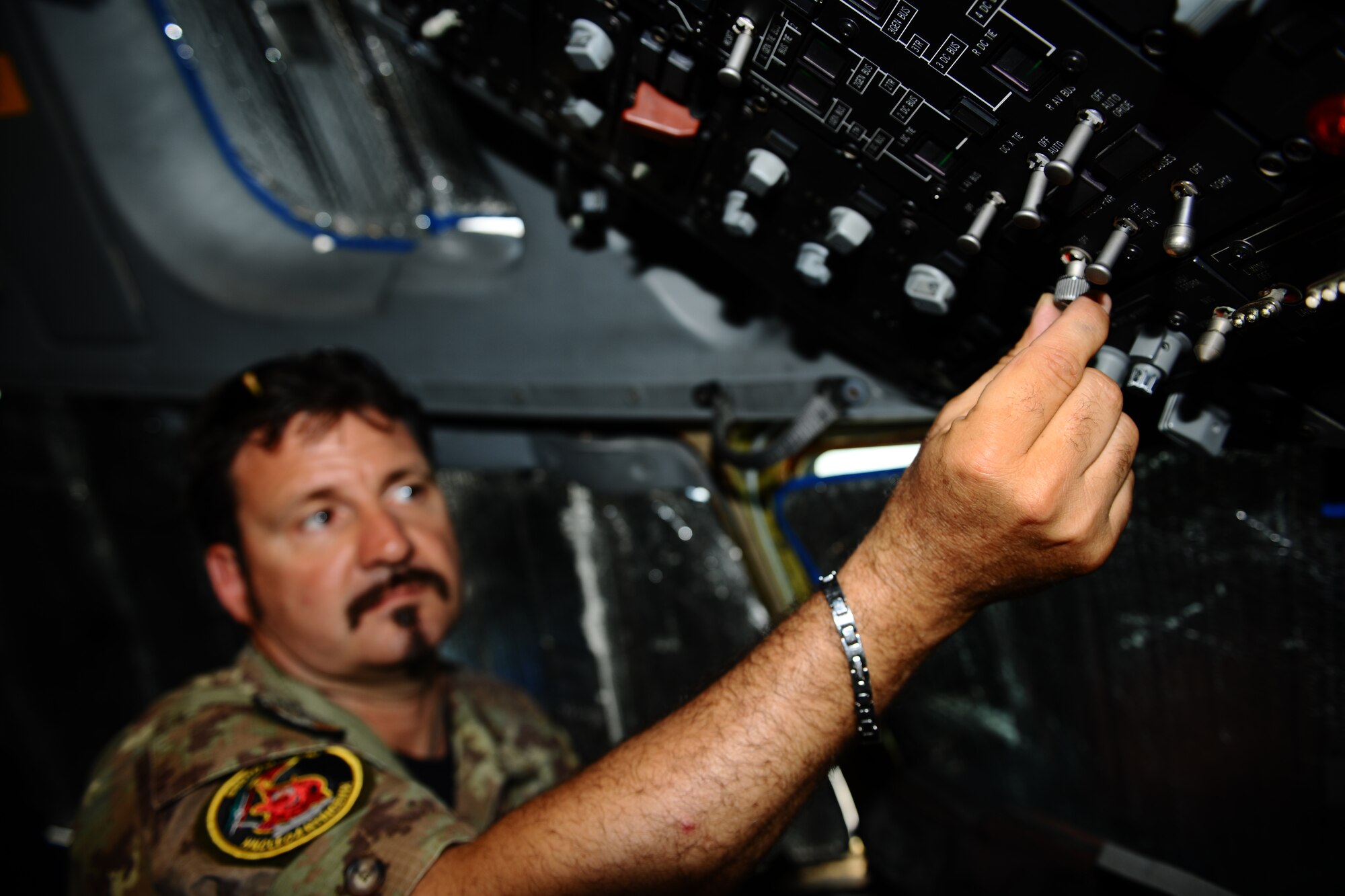 SPANGDAHLEM AIR BASE, Germany – Italian air force Warrant Officer 4 Michele Saracino, NATO firefighter, shows how to perform an emergency shut down on a C-17 Globemaster III during emergency entrance and egress training on Ramp 5 here May 22. NATO firefighters from Germany, Italy, Belgium and the Netherlands participated in the training to enable them to teach firefighters at their base to safely and quickly enter and exit a C-17 during emergency situations. (U.S. Air Force photo by Airman 1st Class Matthew B. Fredericks/Released)
