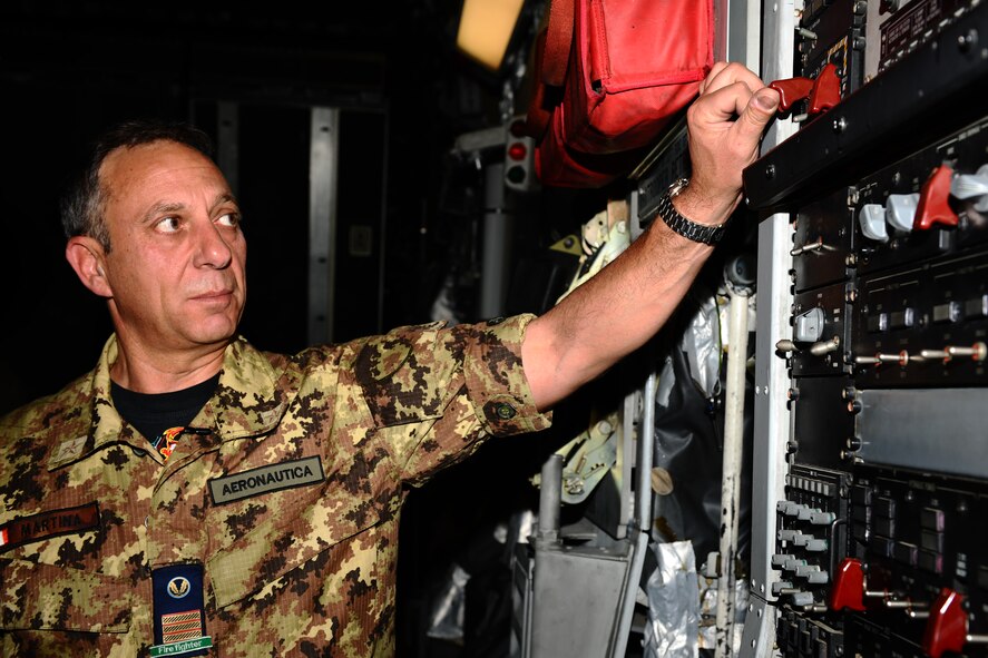 SPANGDAHLEM AIR BASE, Germany – Italian air force Warrant Officer 4 Francesco Martina, NATO firefighter, shows fellow firefighters how to drop the cargo bay door of a C-17 Globemaster III during emergency entrance and egress training on Ramp 5 here May 22. NATO firefighters from Germany, Italy, Belgium and the Netherlands participated in the training to enable them to teach firefighters at their base to safely and quickly enter and exit a C-17 during emergency situations. (U.S. Air Force photo by Airman 1st Class Matthew B. Fredericks/Released)
