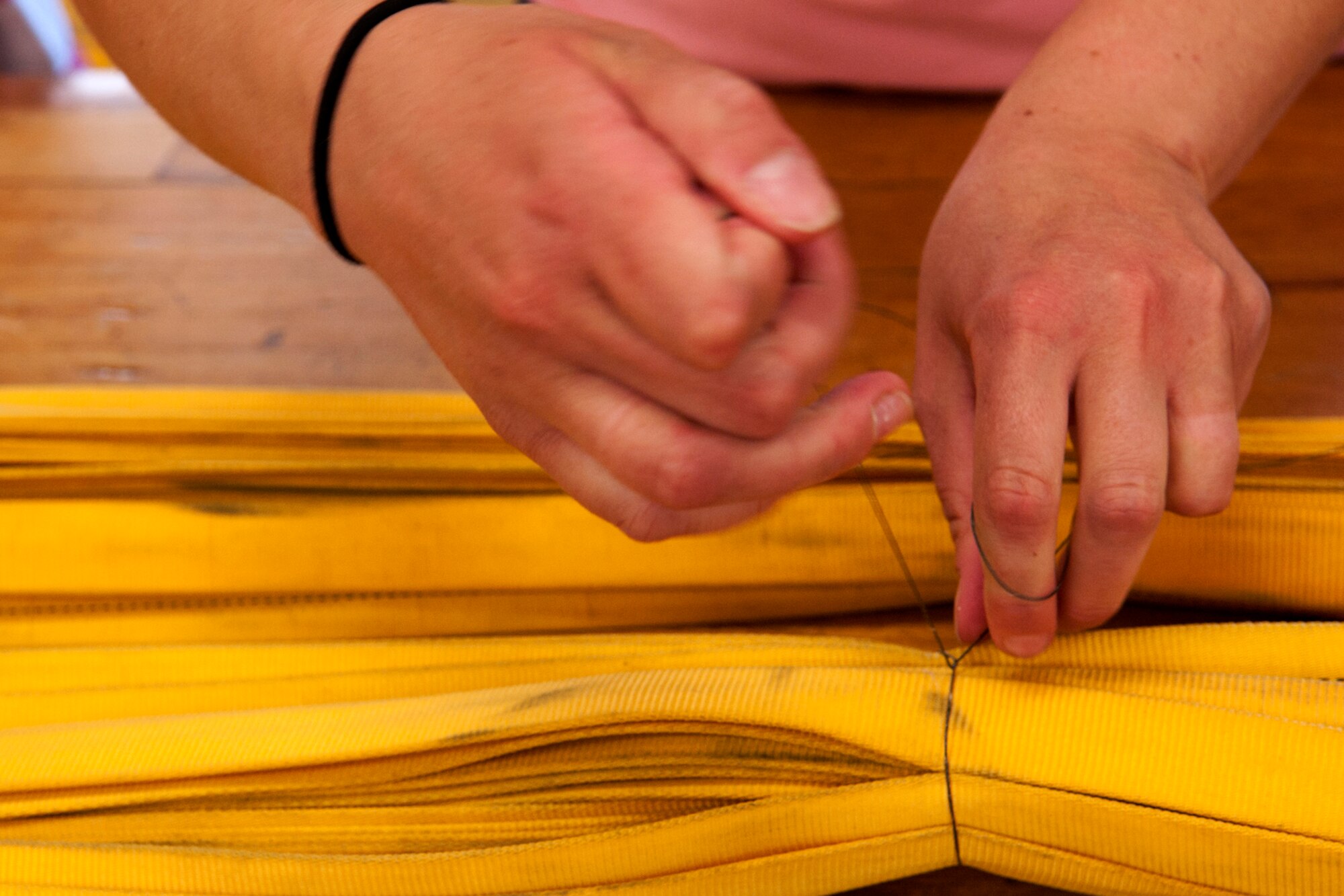 A 2nd Operations Support Squadron (OSS) member's spouse helps tie together straps of a B-52H Stratofortress drag chute during Spouse Appreciation Day, Barksdale Air Force Base, La., May 22, 2012. The 2nd OSS hosted the event and spouses were treated to hands-on demonstrations, along with a tour of a B-52 and training simulator. (U.S. Air Force photo by Master Sgt. Greg Steele/Released)