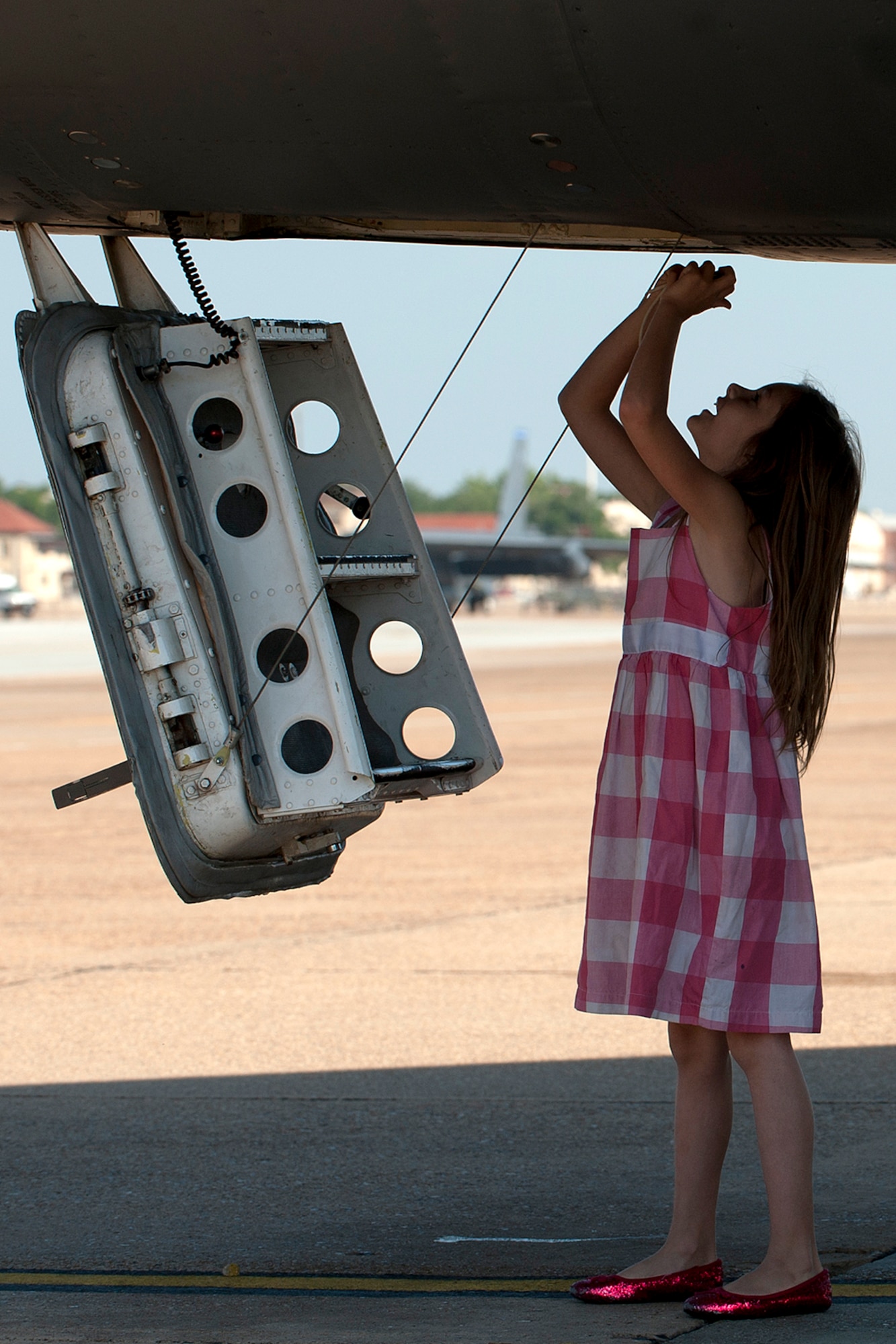 Paige Rimsky looks up the hatch of a B-52H Stratofortress during Spouse Appreciation Day, Barksdale Air Force Base, La., May 22, 2012. Paige is the daughter of U.S. Air Force Lt. Col. Michael Rimsky, 2nd Operations Support Squadron director of operations. (U.S. Air Force photo by Master Sgt. Greg Steele/Released)
