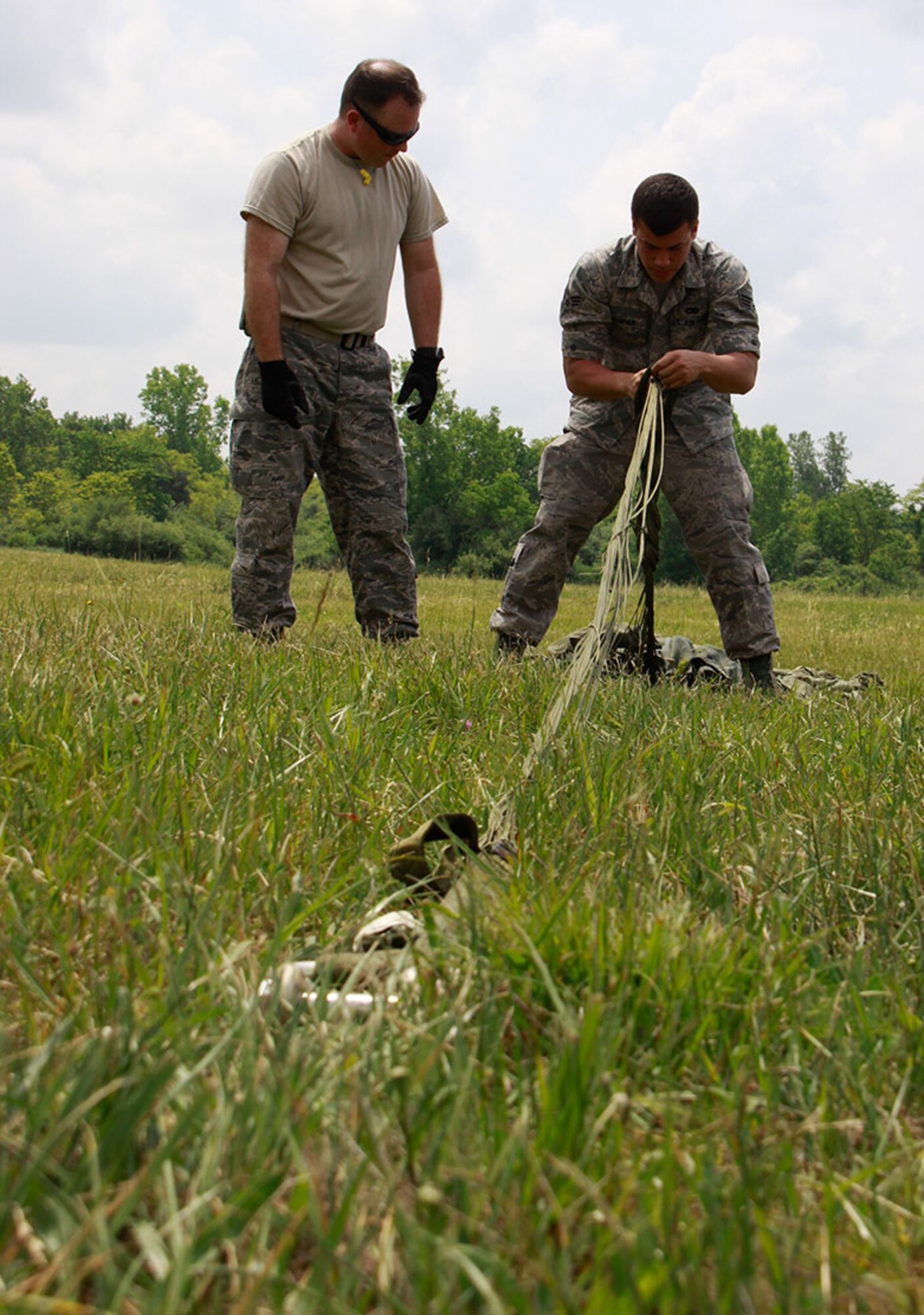 PITTSBURGH IAP ARS -- Airmen from the 911th Airlift Wing, Air Force Reserve Command and the 171st Air Refueling Wing, Pennsylvania Air National Guard, train together during an Honorary Commander’s drop zone event, May 23, 2012, at the Starvaggi Drop Zone site located near Burgettstown, Pa.  The event provided the opportunity for aerial port squadron members from both organizations to work together retrieving air drops and preparing parachutes for further use. (U.S. Air Force photo by Airman 1st Class Justyne Obeldobel/Released)