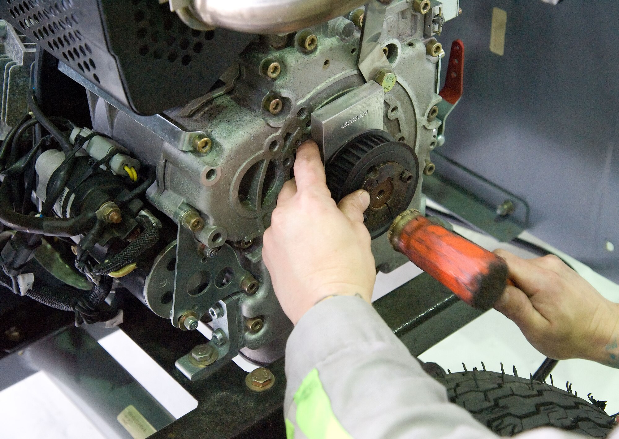 Belts are replaced on a piece of ground equipment May 23, 2012, at Dover Air Force Base, Del. The Aerospace Ground Equipment Flight is responsible for maintaining the majority of aircraft maintenance equipment on the flightline. (U.S. Air Force photo by Adrian R. Rowan)