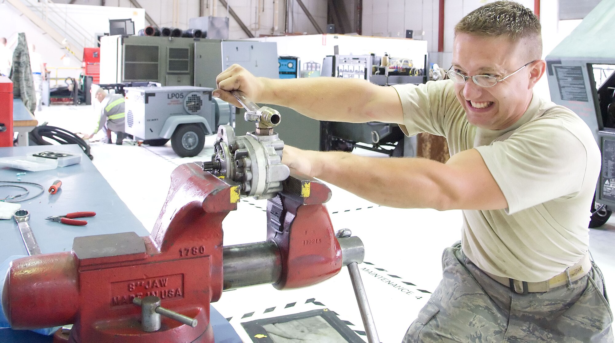 Senior Airman Karl Witt, aerospace ground equipment mechanic with the 436th Maintenance Squadron, loosens a bolt on a piece of ground equipment May 23, 2012, at Dover Air Force Base, Del. The Aerospace Ground Equipment Flight is responsible for maintaining the majority of aircraft maintenance equipment on the flightline. (U.S. Air Force photo by Adrian R. Rowan)