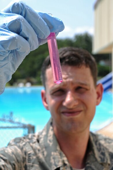 Staff Sgt. Mario Falcone, 2nd Aerospace Medicine Squadron, looks at a sample taken from a pool on Barksdale Air Force Base, La., May 23. The pools are tested for chlorine, bacteria and potential hydrogen levels to ensure Barksdale swimmers are safe. (U.S. Air Force photo/Airman 1st Class Micaiah Anthony)(RELEASED)