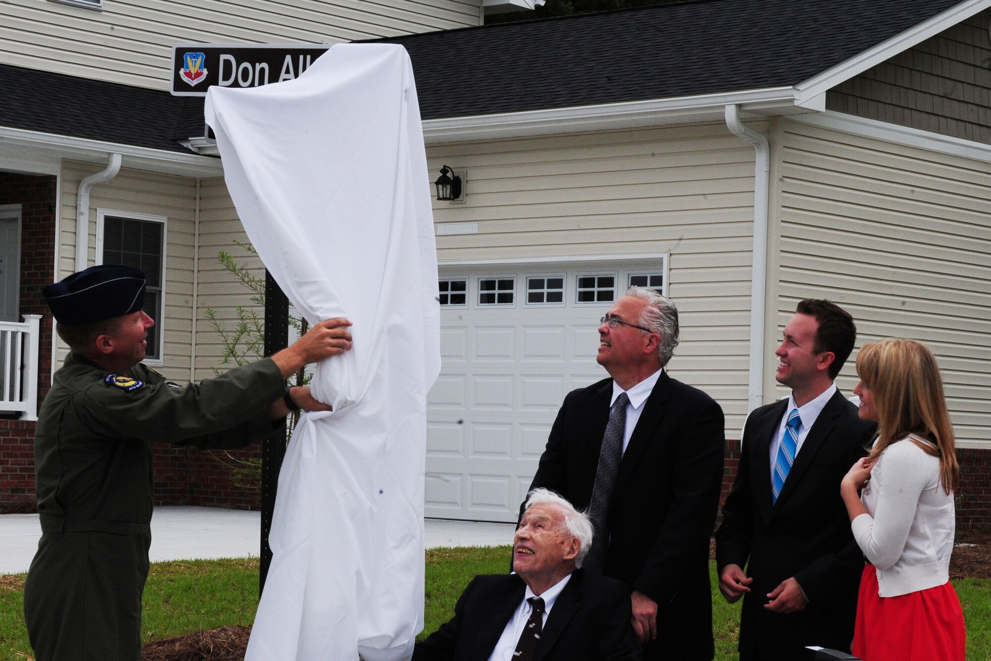 U.S. Air Force Col. Patrick Doherty unveils the street sign for Don Allen Court as the Allen family watches on Seymour Johnson Air Force Base, N.C., May 18, 2012. The street was named after Staff Sgt. Don Allen, a World War II veteran, who served as a maintainer in the 334th Fighter Squadron. While assigned to the 334th FS Allen painted nose art on 56 aircraft. Reproductions of Allen’s art hang in the Seymour Johnson Consolidated Support Center. Doherty, the 4th Fighter Wing commander, is from Bellevue, Neb. (U.S. Air Force photo/Tech. Sgt. Tammie Moore/Released)