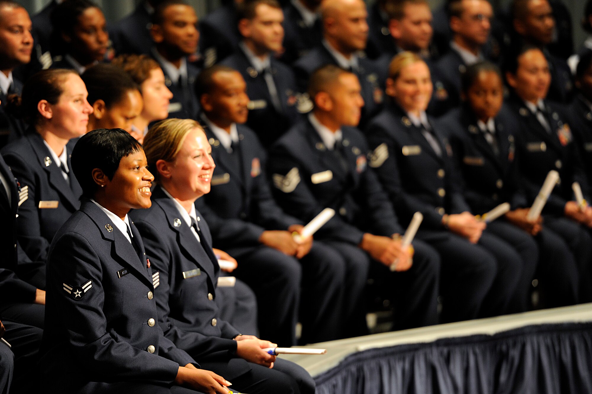 Community College of the Air Force graduates get their degrees during the graduation ceremony at the Keystone Theater on Kadena Air Base, Japan, May 24, 2012. A CCAF degree, requiring at least 64 college credit hours, is essential for U.S. Air Force Airmen in order to progress through the enlisted ranks and further their careers. (U.S. Air Force photo/Airman 1st Class Maeson L. Elleman)