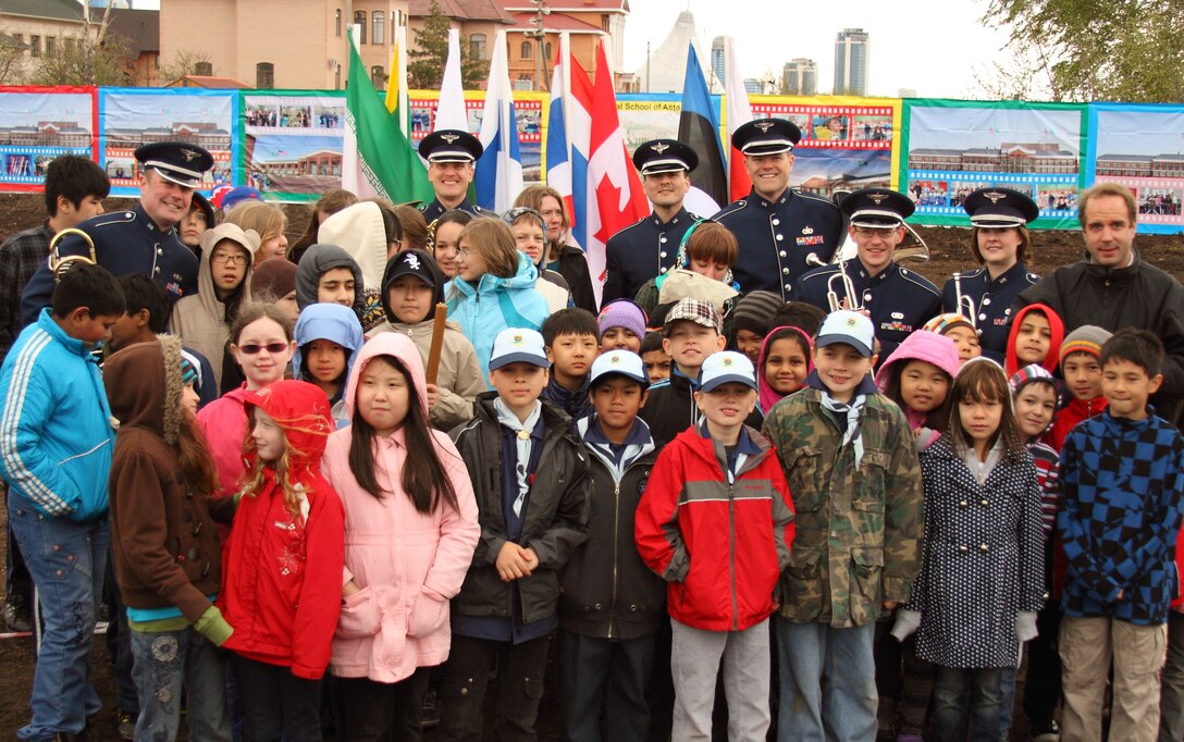 The Five Star Brass pose for a photo with students at the ground breaking ceremony.  These are the children of military and civilian members from various nations that are working in Kazakhstan.