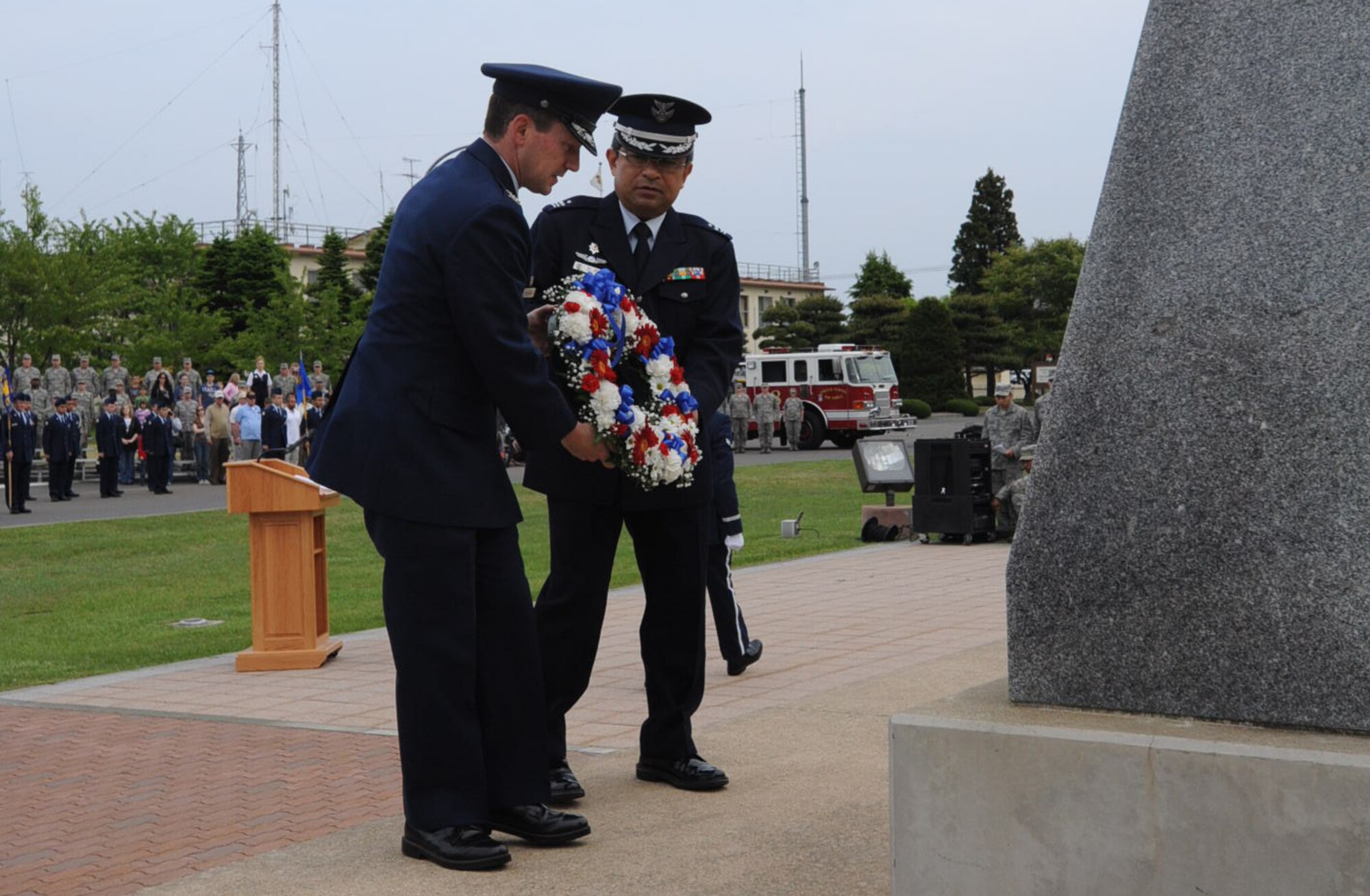 Col. Michael Rothstein, 35th Fighter Wing commander, left, and Col. Hitohiko Iwasaki, Japan Air Self-Defense Force 3rd Air Wing vice commander, place a wreath at the base of the monument in Risner Circle during the Memorial Day retreat ceremony at Misawa Air Base, Japan, May 24, 2012. More than 150 members of the base community gathered for the event. (U.S. Air Force photo by Airman Kenna Jackson/Released)
