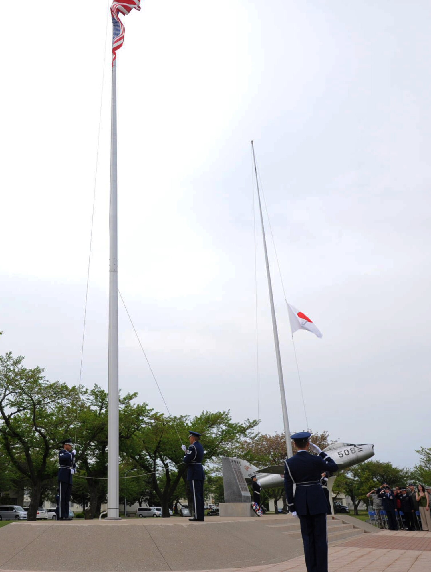 U.S. Air Force Honor Guard and Japan Air Self-Defense Force members lower the flags at Risner Circle during a Memorial Day retreat ceremony at Misawa Air Base, Japan, May 24, 2012. The ceremony gave Airmen, Sailors, Soldiers and community members the opportunity to honor U.S. servicemembers who have fallen in defense of the U.S. nation. Memorial Day was originally called Decoration Day and began May 30, 1868. (U.S. Air Force photo by Airman Kenna Jackson/Released)
