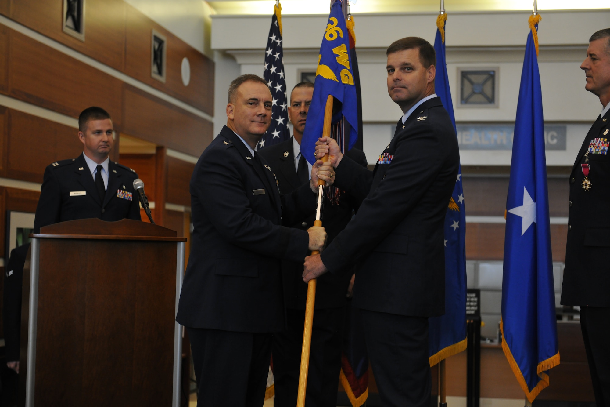 ANDERSEN AIR FORCE BASE, Guam - Brig. Gen. John Doucette (left), 36th Wing
commander, passes the 36th Medical Group guidon to Col. Bert Scott, newly
appointed 36 MDG commander, during a change of command ceremony at the 36
MDG May 24. (U.S. Air Force photo by Senior Airman Benjamin
Wiseman/Released)