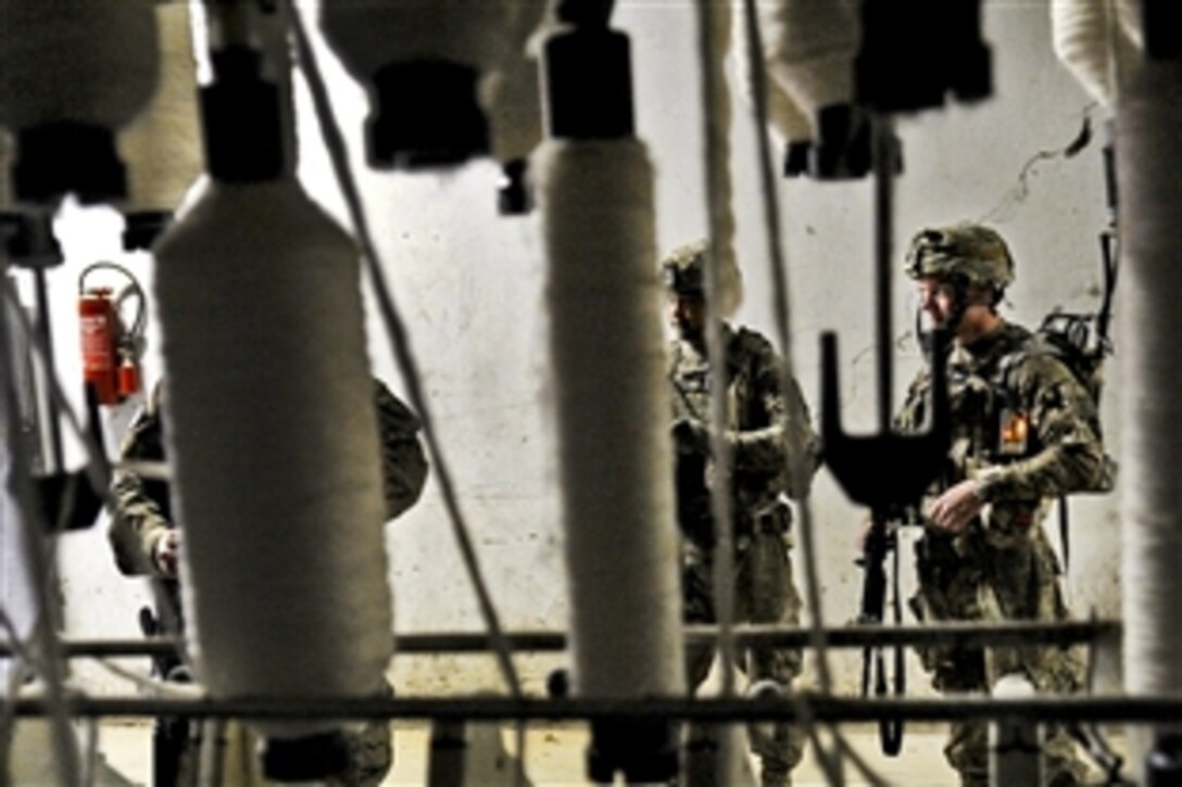 Kandahar Provincial Reconstruction Team members survey a textile factory in Afghanistan's Kandahar province, May 23, 2012. The team includes U.S. service members and civilians helping to rebuild and stabilize the local government and infrastructure.